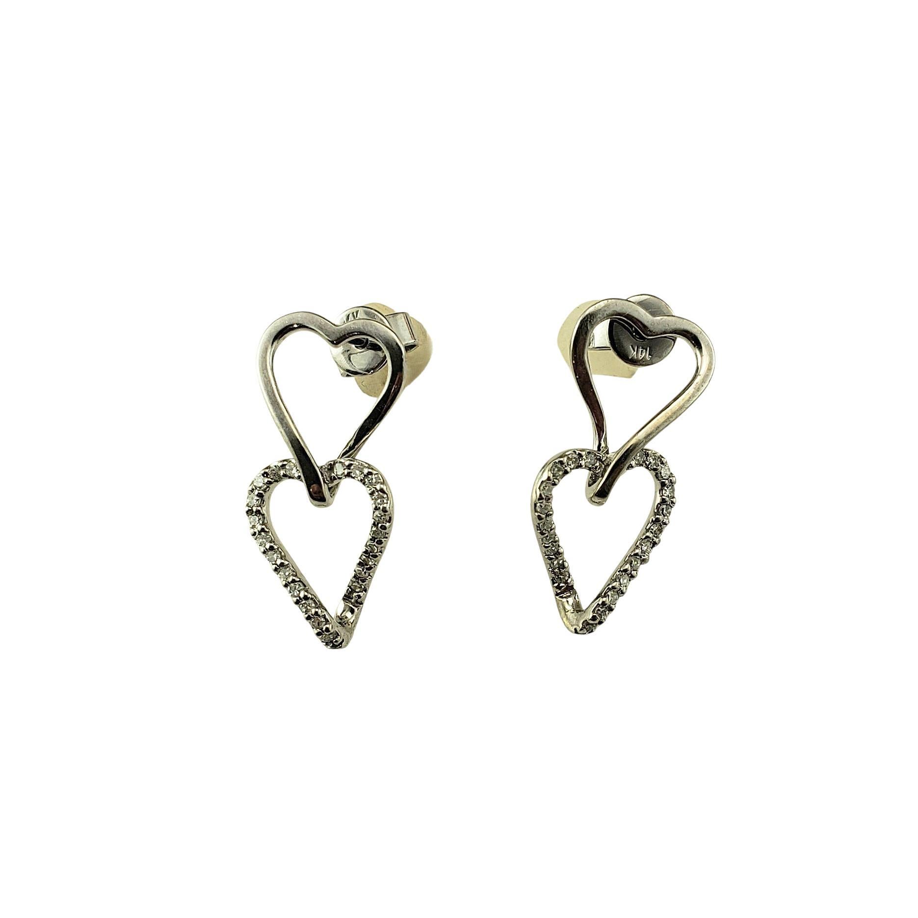 14K White Gold and Diamond Dangle Heart Earrings-

These romantic dangling heart earrings each feature 22 round single cut diamonds set in classic 14K white gold. With just the right amount of sparkle, these earrings are perfect for both everyday