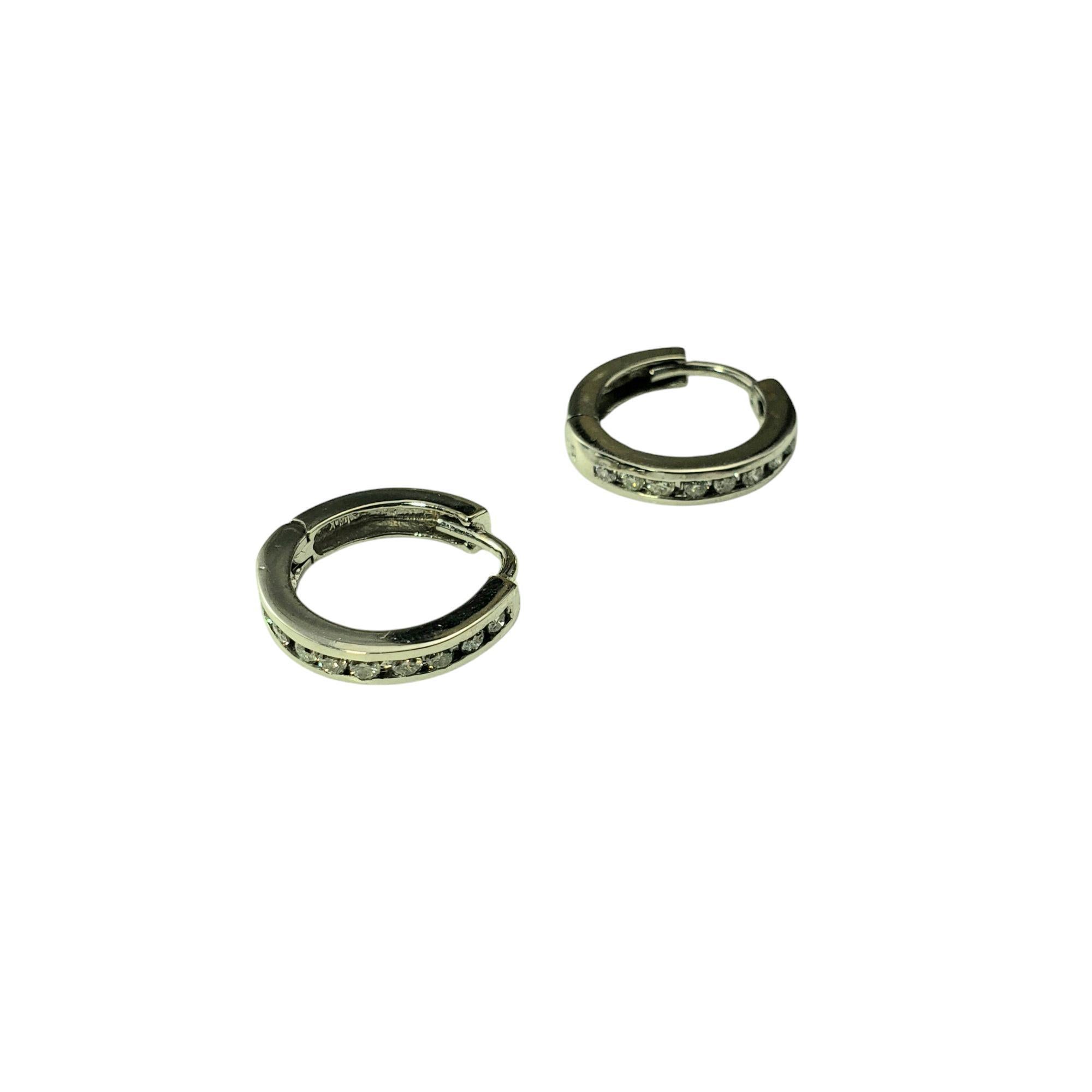 14K White Gold and Diamond Hoop Huggie Earrings-

These sparkling hinged hoop earrings each feature 10 round brilliant cut diamond set in classic 14K white gold.

Approximate total diamond weight: .25 -  .30 ct.

Diamond color: J-K

Diamond clarity: