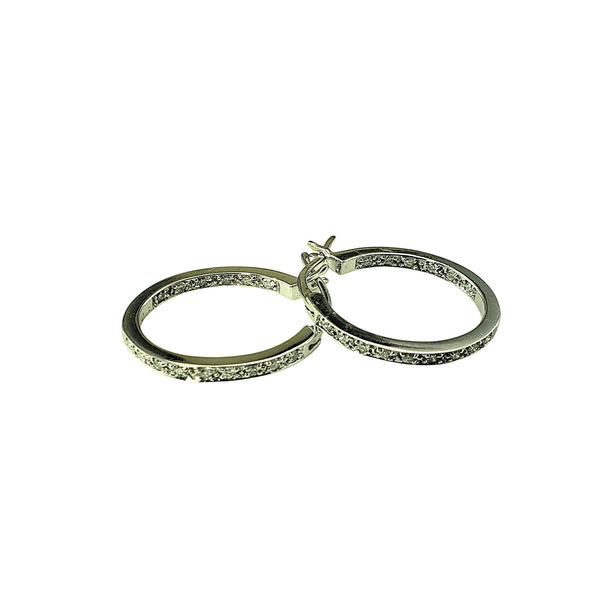 14K White Gold and Diamond Inside-Out Hoop Earrings-

Crafted in elegant 14K white gold, these oval hoop earrings are each set with 15 round brilliant cut diamonds-placed both on the front and inside of the hoop-for maximum sparkle from every angle.