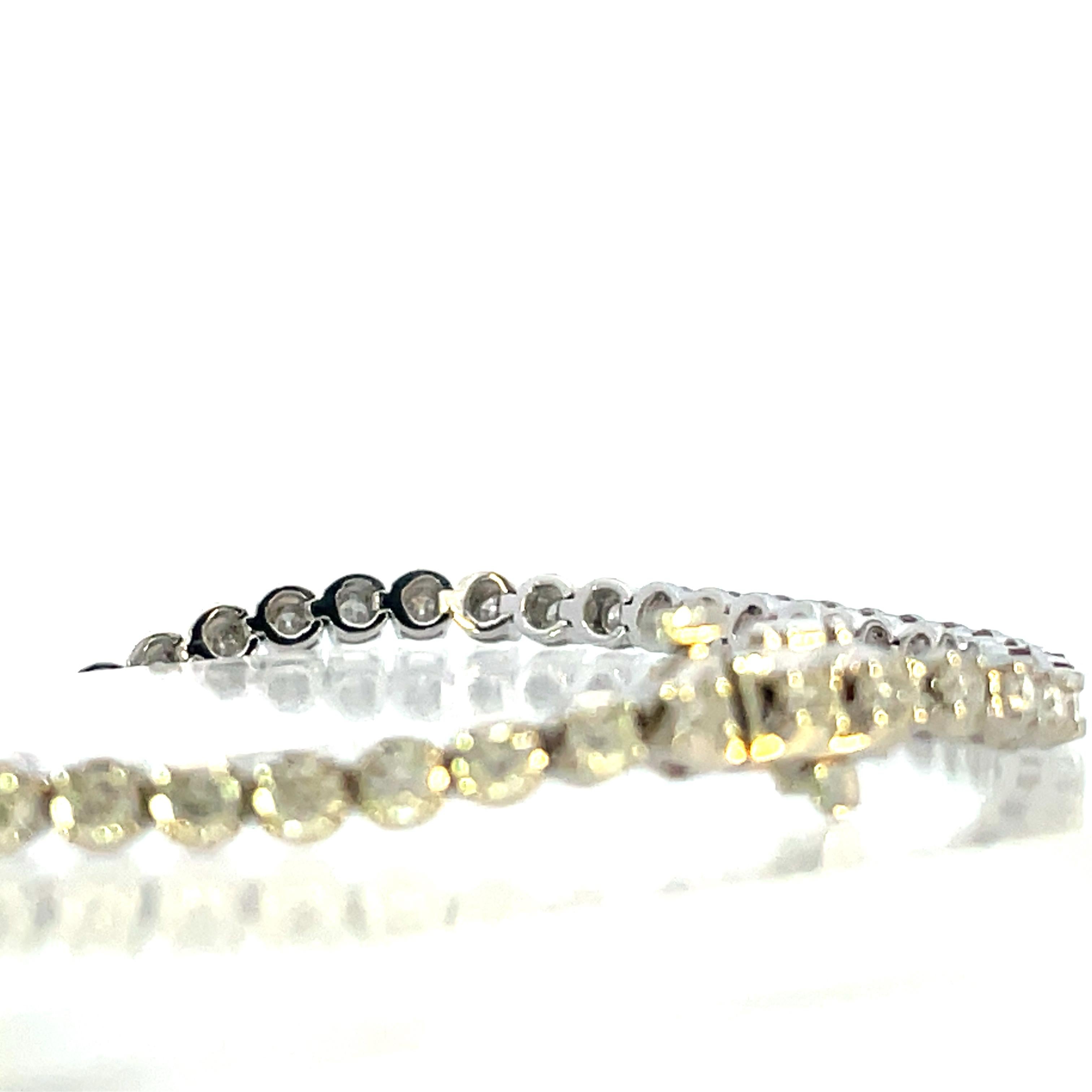 This is an incredibly beautiful 14k white gold 7” tennis diamond bracelet. The straight line design ensures the bracelet will not spin or rotate on the wrist and the diamonds are always facing up and shining brightly. This, combined with the