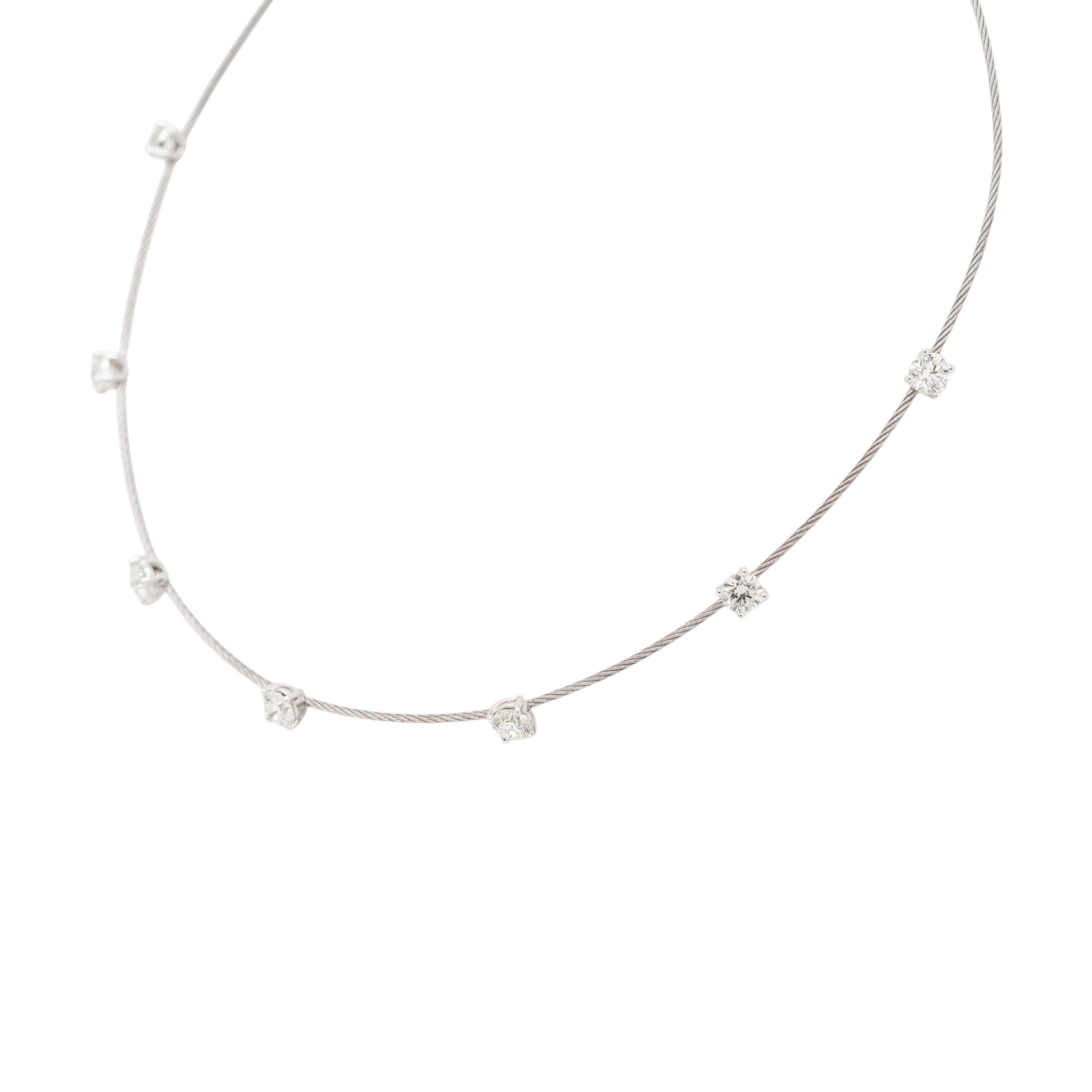 This elegant choker necklace combines modern design with timeless luxury. Crafted from 14k white gold and stainless steel, it features a sleek cable-style band adorned with seven dazzling round diamonds, totaling approximately 3.52 carats. Each
