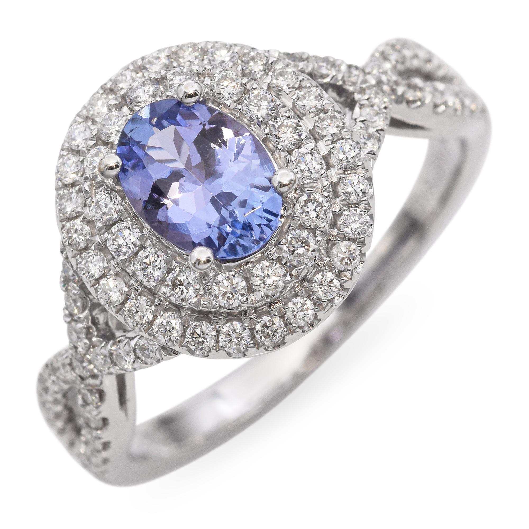This 14k white gold statement ring features an 0.7ct oval-cut tanzanite with vivid violet-blue hues that shimmer beautifully in the light. The center stone is set in a secure four-prong setting, allowing maximum brilliance and visibility. The