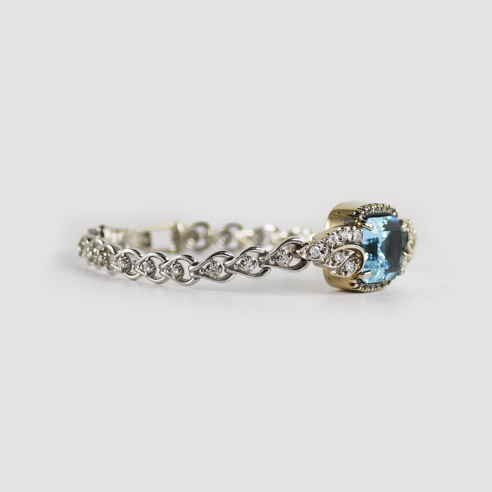 Antique diamond watch conversion to bracelet.
Stamped 14k white gold and weighs 18 grams.
The blue topaz is rectangle-shaped with a step cut, 13.5mm by 11mm.
Excellent color and cut.
There are 1.00 total carats of round diamonds, G to H color, VS