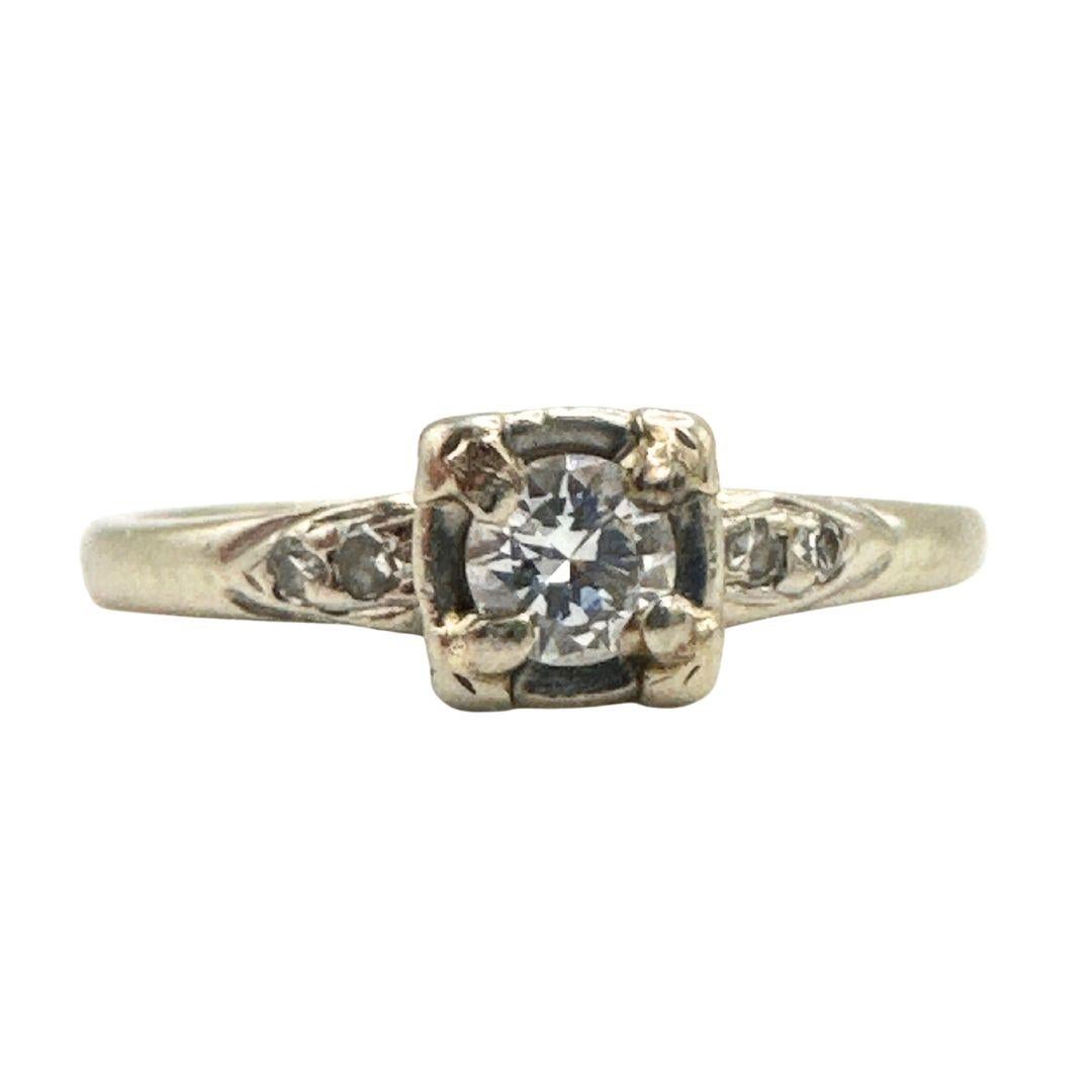 Explore a realm of enduring elegance with the 14K White Gold Antique Solitaire Ring, distinguished by a captivating diamond at its center. This carefully crafted piece seamlessly marries the charm of yesteryears with a touch of modernity, offering a
