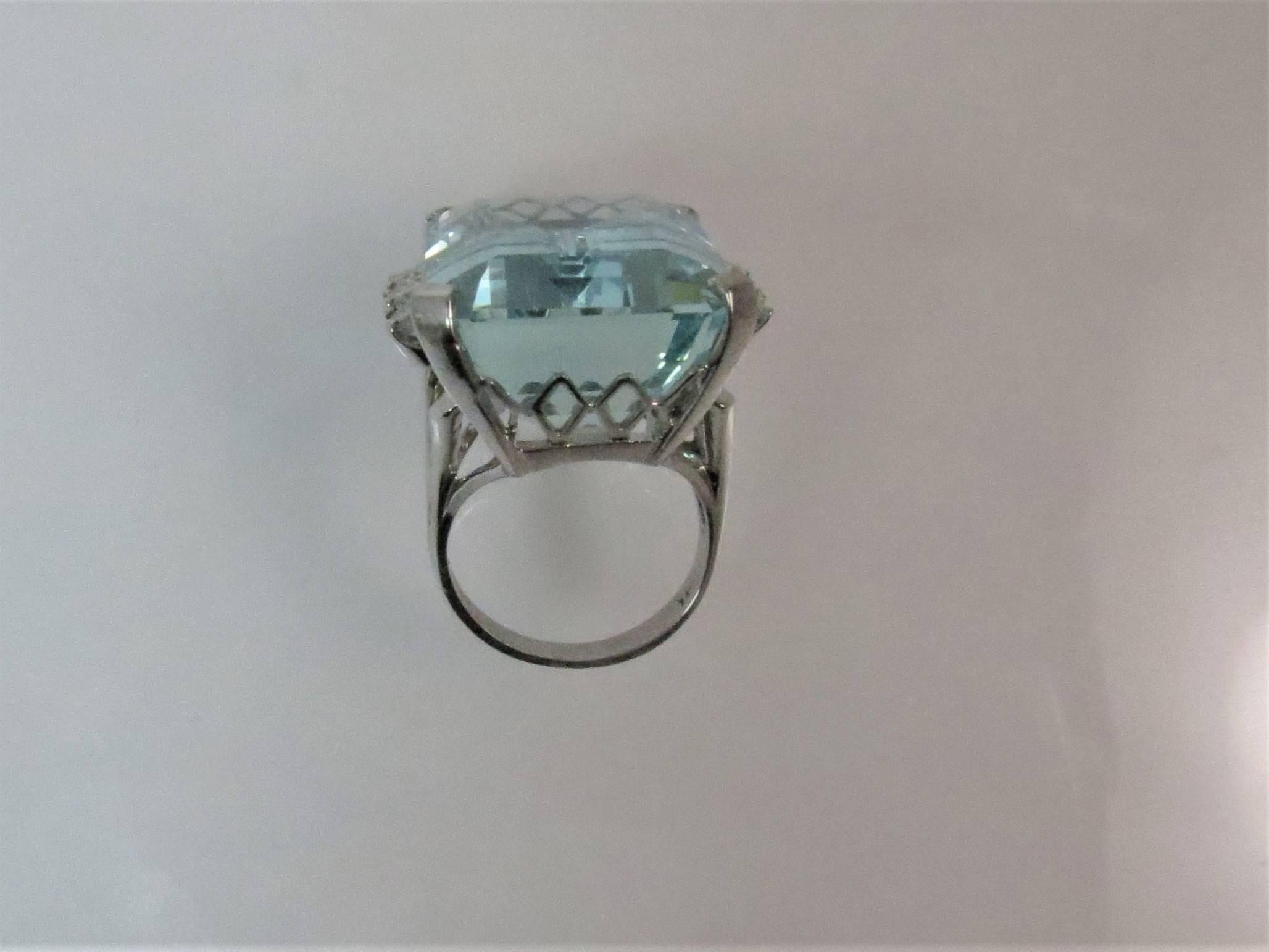  Gorgeous 14K white gold ring prong set with emerald cut aquamarine weighing 44.20cts and 6 full cut round diamonds weighing .84cts, H-I color, SI1 clarity 
Finger size 6, may be sized