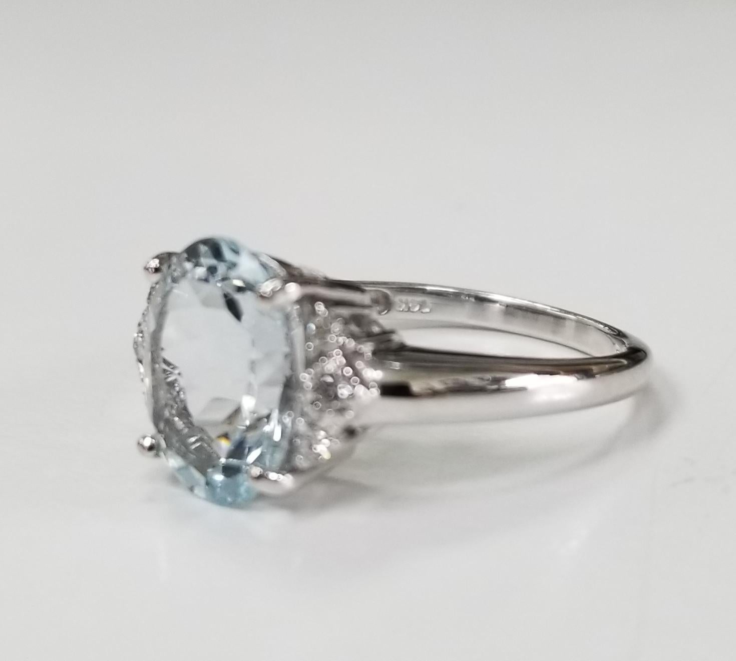 14k white gold aquamarine and diamond ring containing 1 oval aquamarine of gem quality weighing 2.86cts. and 6 round diamonds weighing .14pts.  This ring is a size 7 but we will size to fit for free.