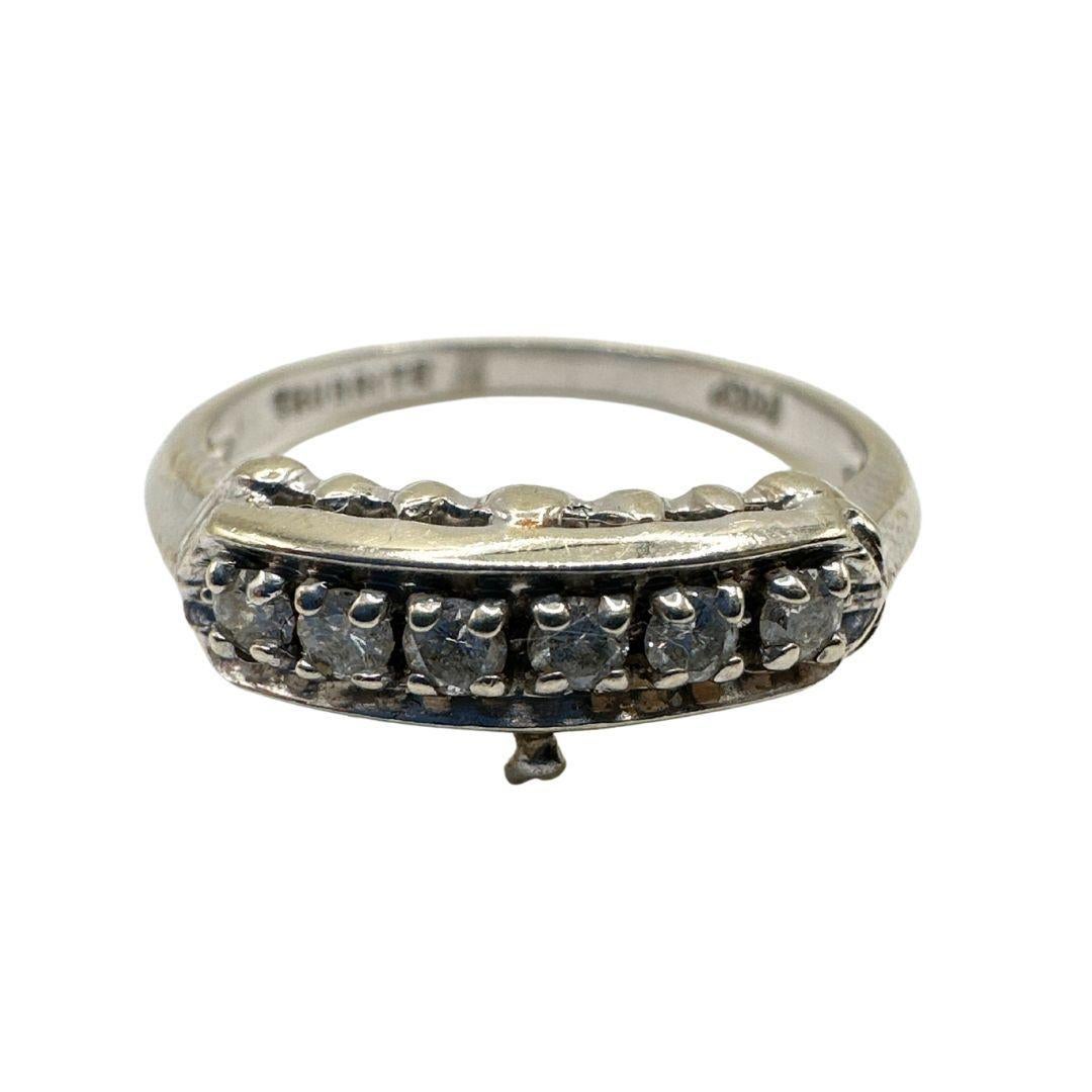 Step into the captivating era of Art Deco with this enchanting antique ring, meticulously crafted in 14k white gold and adorned with brilliant-cut diamonds. Rather than adopting a promotional tone, let's explore the details of this piece and