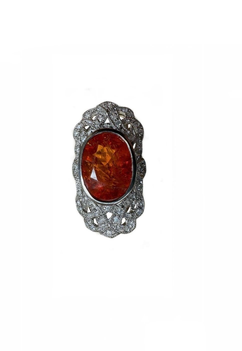 DeKara Design Collection 

Metal- 14K White Gold, .583.  18 Grams.

Stones- Oval Spessartite Garnet 17.50 Carats, 40 Round Diamonds F-G Color SI1-SI2 Clarity 1.00 Carats.

Size- 8 1/2.  Free Sizing.  

Art Deco Inspired 14K White Gold Diamond