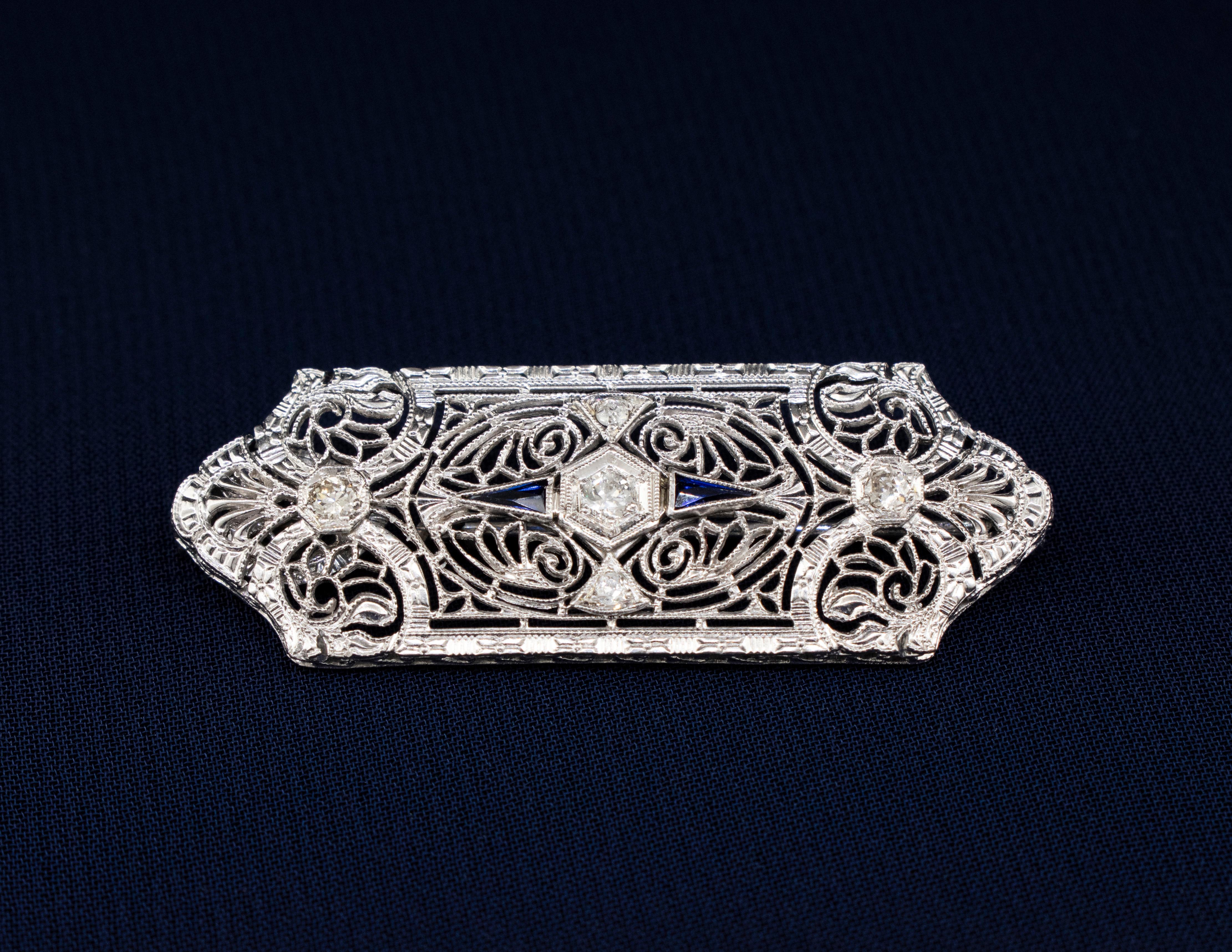 An Antique 14k White Gold, Diamond and Sapphire Brooch/Pendant. This piece is a fine example of the 