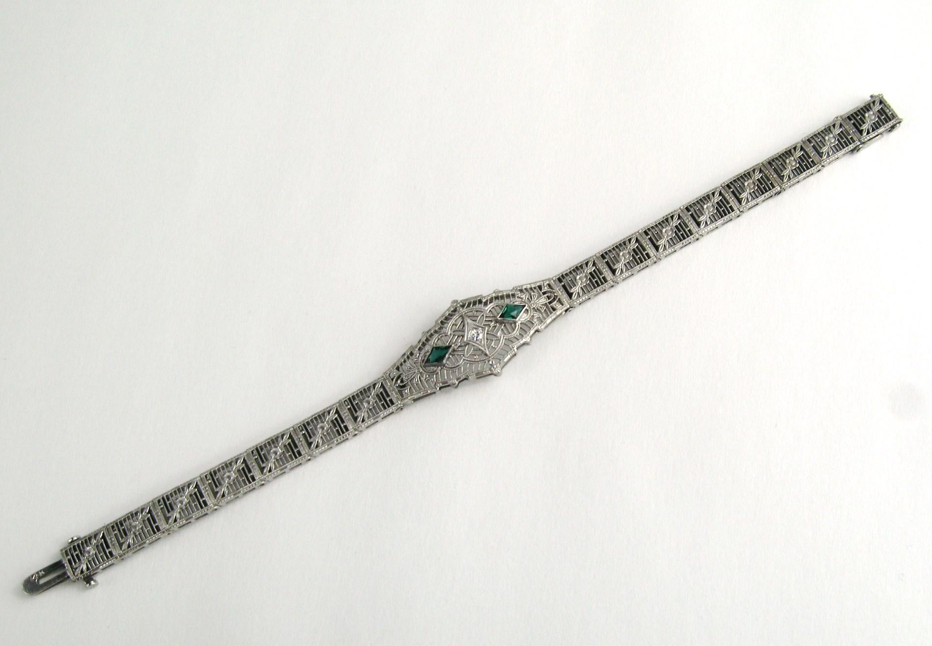 Stunning 1920s Art deco Bracelet, green glass stones with a diamond accent center. Set in 14K white gold. This measures .59