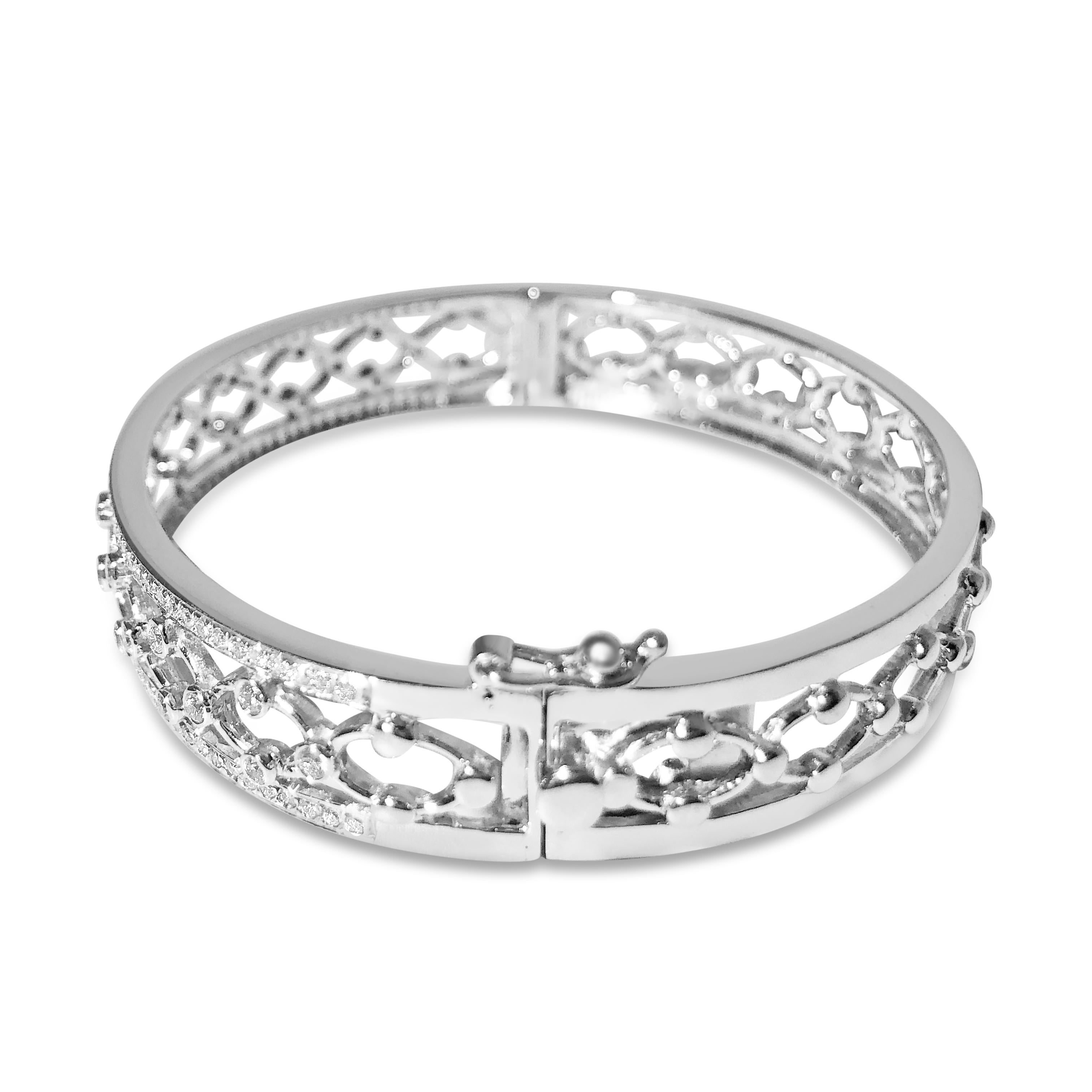 Our “Venice” bracelet is an intricate feat of filigree work set in 14K white gold. 134 round 1.2mm and 1.7mm white diamonds totaling 1.50ct adorn the upward-facing half. The oval-shaped bangle securely closes with a snap & hinge.

Specifications:
-