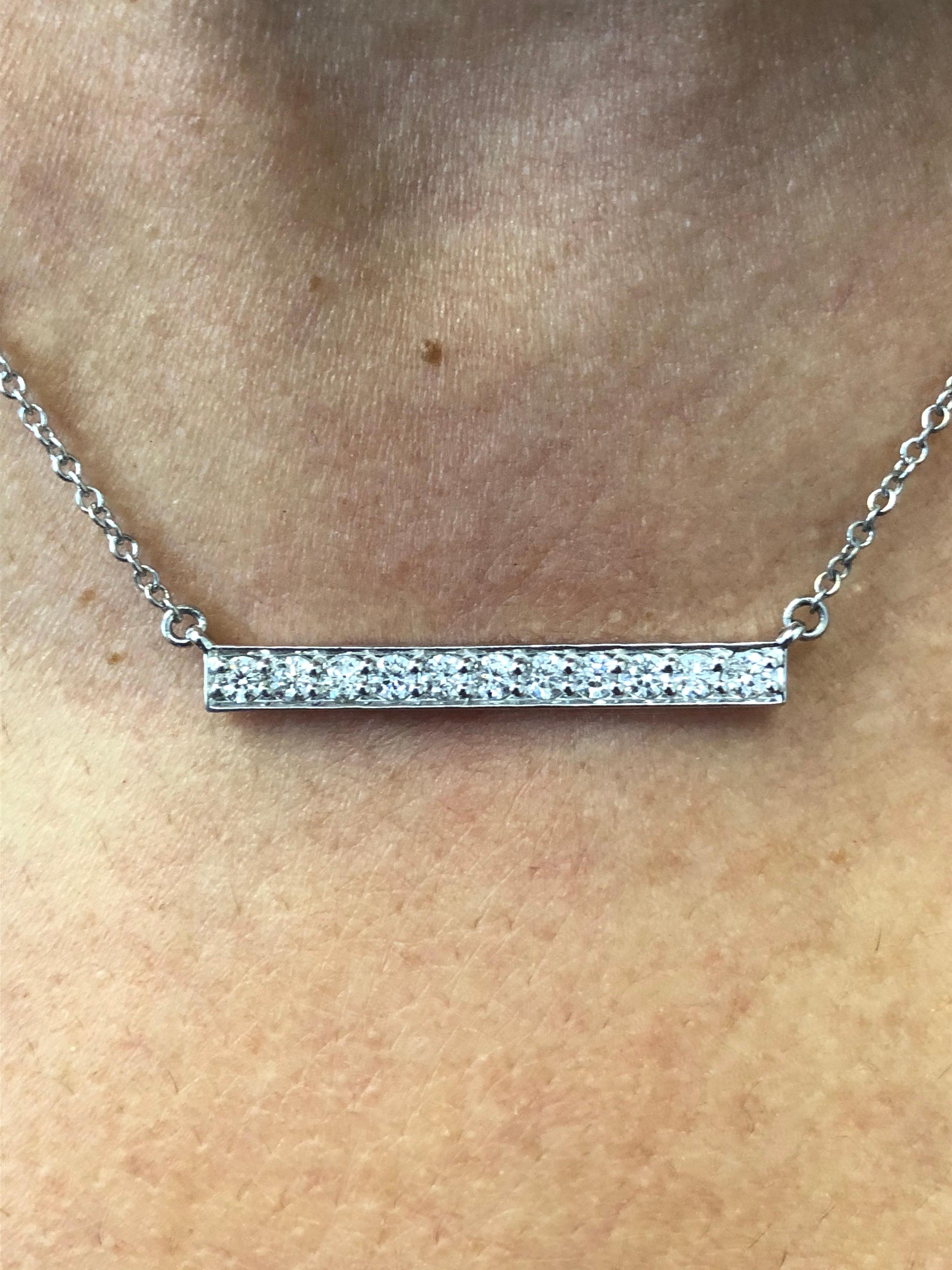 Straight bar diamond pendant set in 14K white gold. The pendant is set with 11 stones and the total weight is 0.88 carats. The color of the stones are G-H, the clarity is SI. The length of the bar is 1.5 inch and the necklace is 16 inches. The