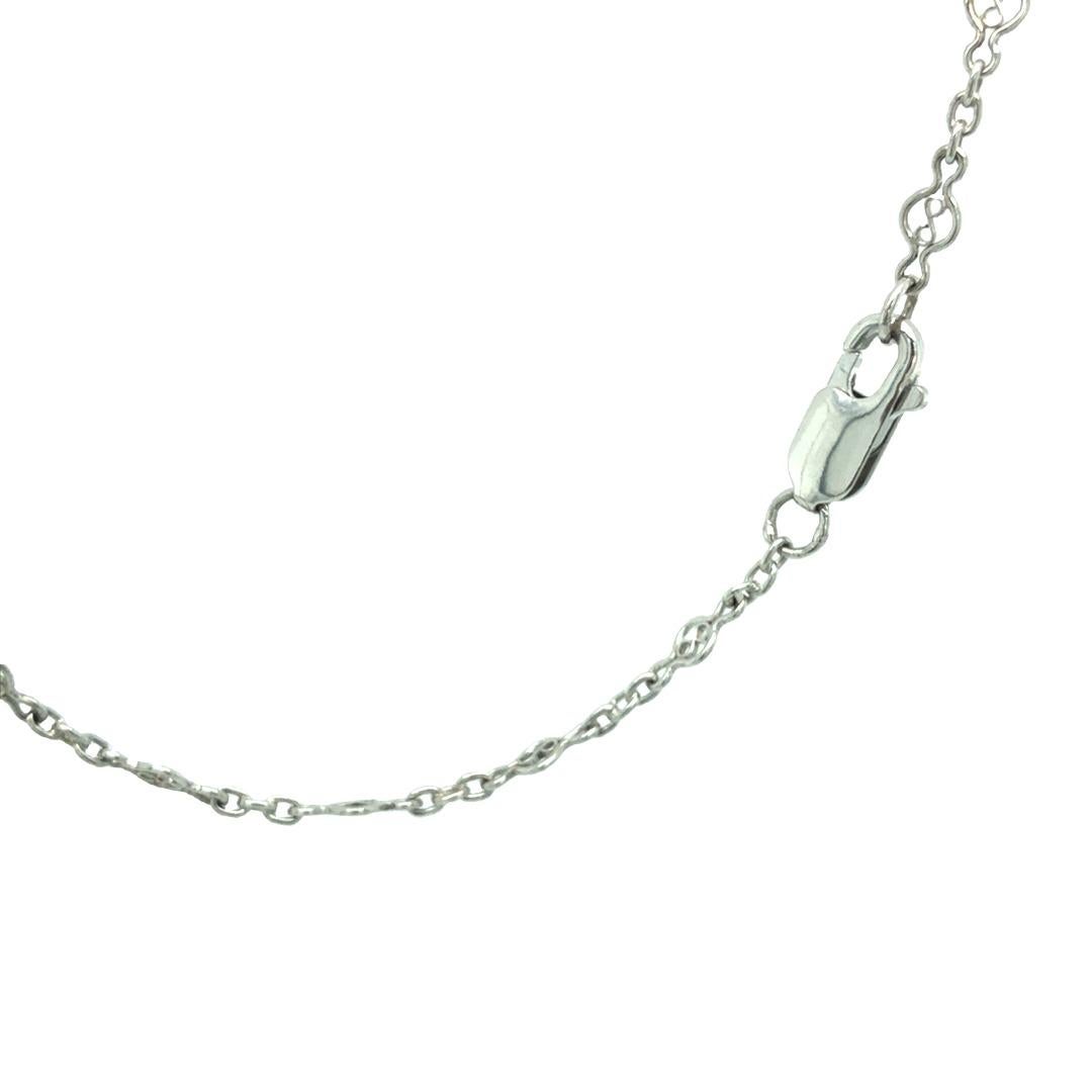 Beautiful rare find -An elegant bezel-set diamond solitaire necklace in 14K white gold, crafted with an intricate figure-8 cable chain. Featuring one round brilliant-cut bezel-set diamond weighing approximately 0.65 carats and boasting G color and