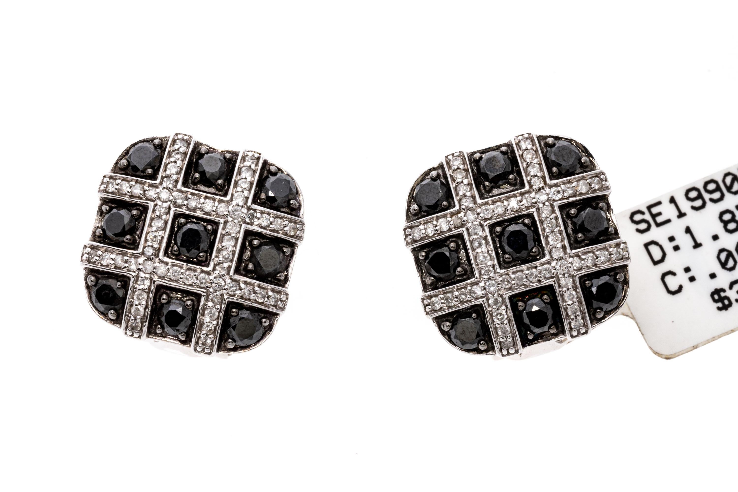 14k White Gold Sophisticated Black And White Diamond Cushion Earrings, 1.87 TCW.
These sophisticated earrings are a rounded cushion, button style with prong set round faceted black diamonds set in between crisscross bars of round faceted, white
