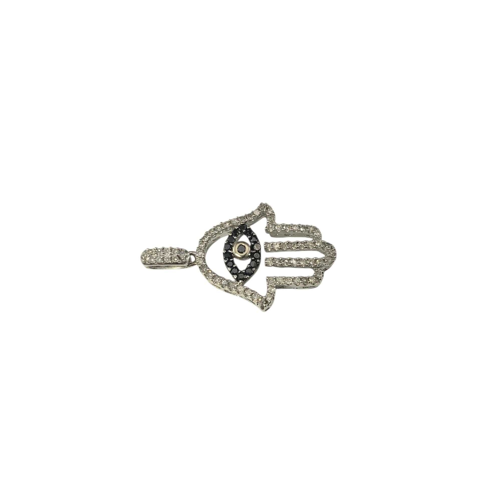 14 Karat White Gold Black and White Diamond Hamsa Pendant-

The Hamsa hand, an ancient symbol of luck and protection, gets a modern upgrade with this 14K white gold pendant, adorned with a mesmerizing mix and black and white diamonds.

Approximate