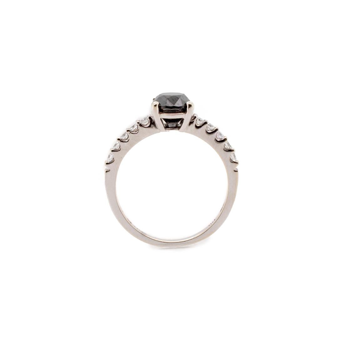 One lady's custom made polished 14K white gold, diamond engagement ring with a soft-square shank. The ring is a size 5. The ring weighs a total of 1.90 grams. Engraved with 