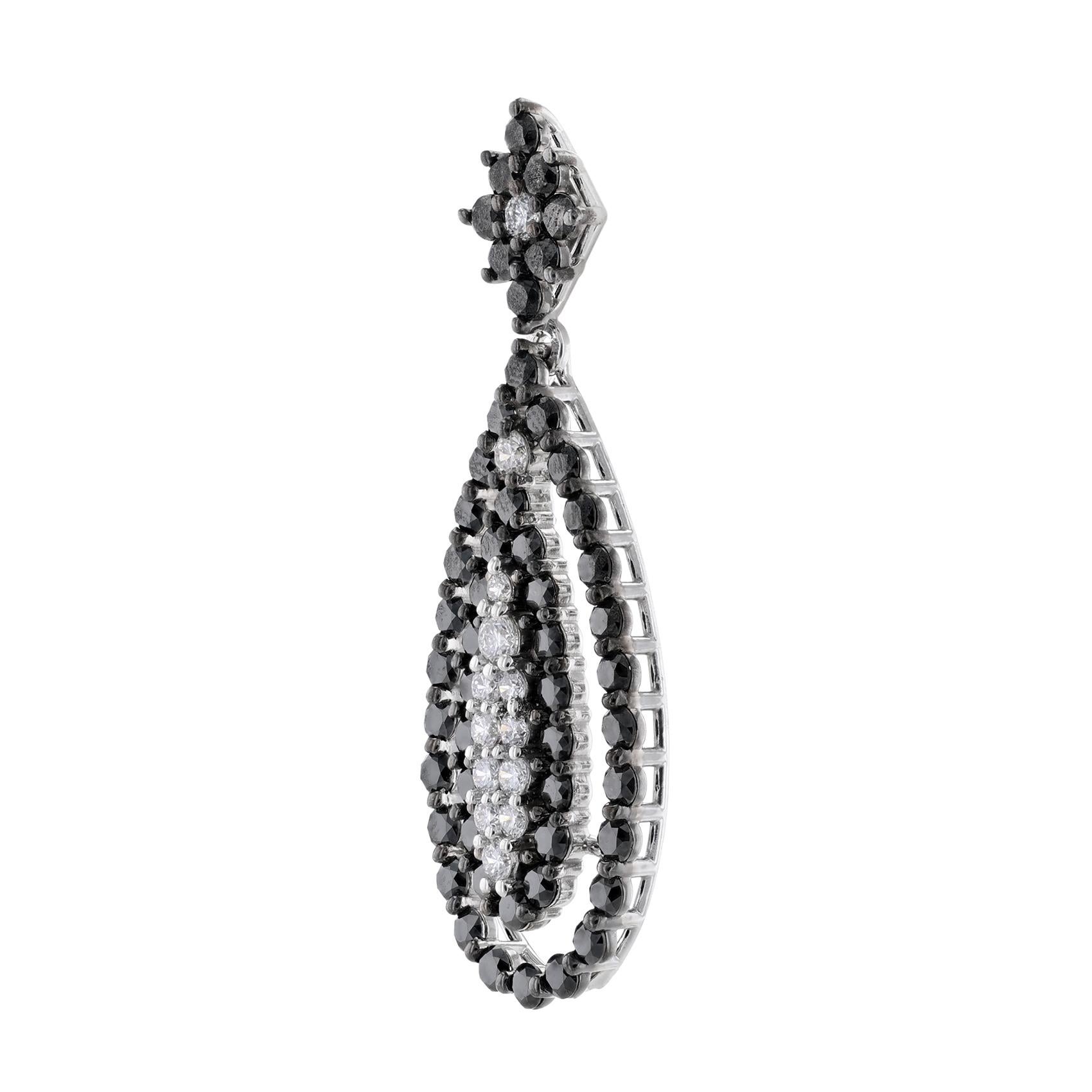 These teardrop shape earrings are made in 14K white gold and feature black diamonds (heat treated) weighing 4.20 carat. Along with round diamonds weighing 0.81 carat. All stones are prong set. 


