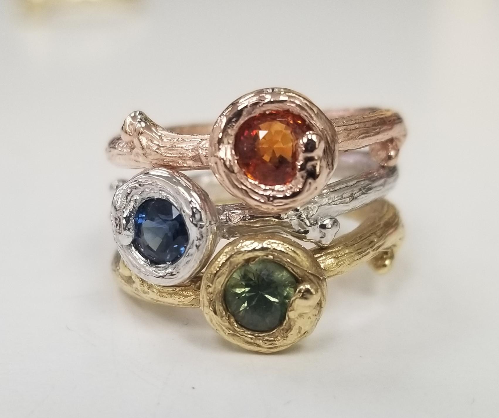 Pick your 14k gold and sapphires to your desire.
14k white gold Gresha signature bark ring with 5mm green sapphire weighing .50pts. and 10 diamonds weighing .10pts. ring has been black rhodium.  
*Available in 14k yellow, white or rose with green,
