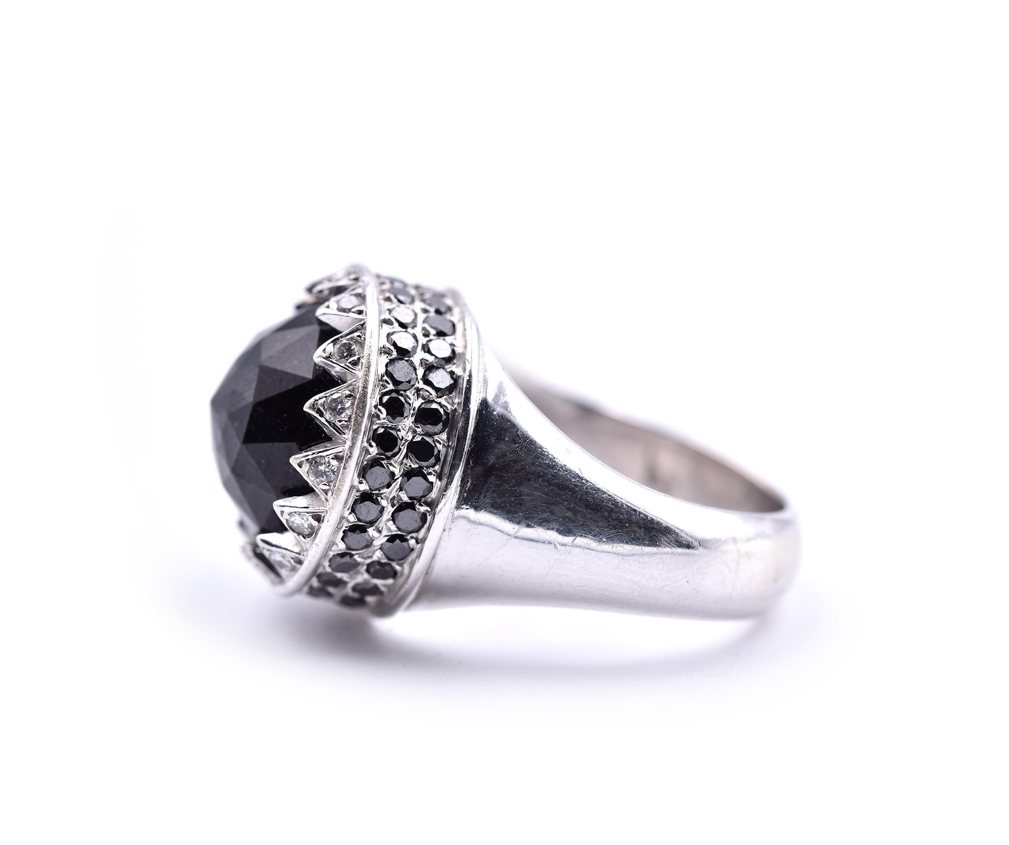 Designer: custom design
Material: 14k white gold
Center Stone: 1 faceted black spinel
Diamonds: 16 round brilliant cuts = 0.16cttw
Black Diamonds: 56 black round diamonds = 0.38cttw
Ring Size: 6 ¾ (please allow two additional shipping days for