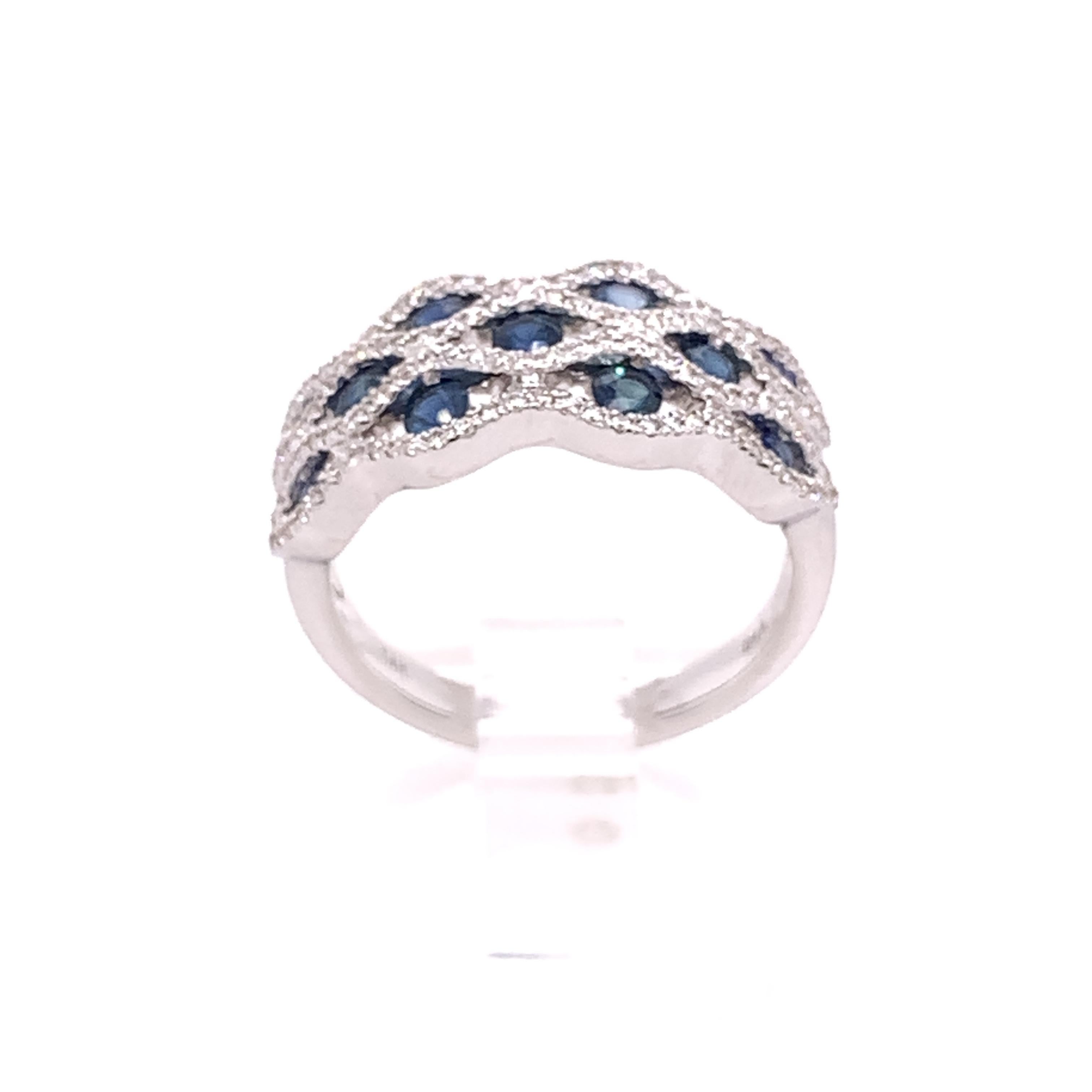 A stunning cocktail ring crafted in luxurious 14 karat white gold with 11 round natural blue sapphire stones, totaling approximately 0.66 carats. 

This ring also contains 118 natural round brilliant diamonds totaling 0.35 carats, G-H color, and