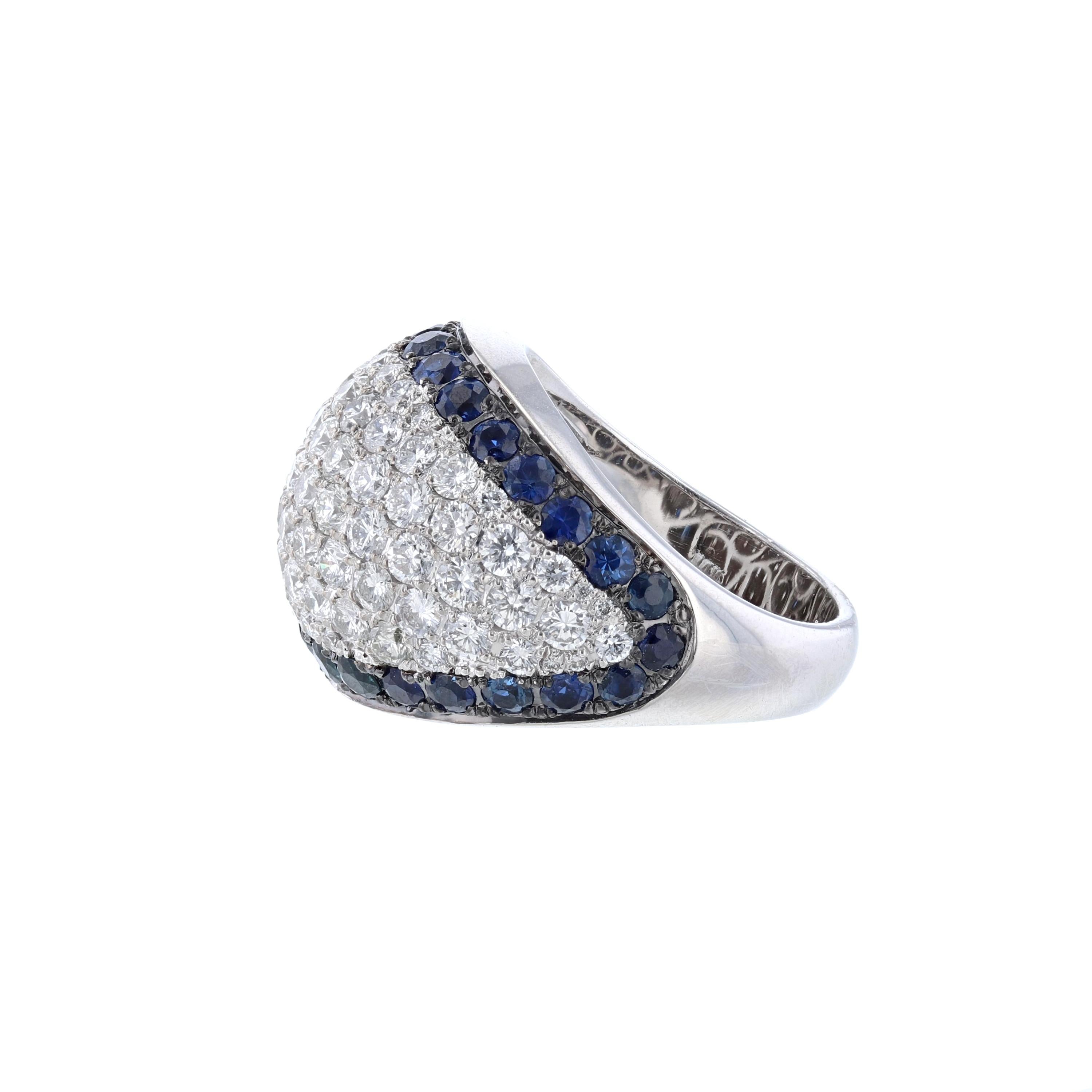 This ring is made in 14K white gold and features 32 round cut blue sapphires weighing 2.16 carats. Also includes 88 round cut diamonds weighing 2.76 carats. With a color grade (H) and clarity grade (SI2) All stones are prong set. with a  color grade