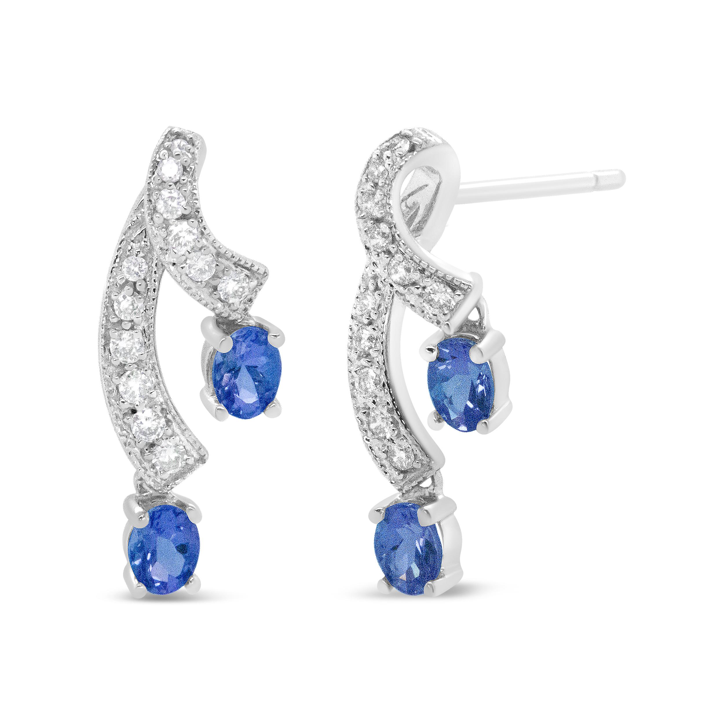 These unique earrings are sure to turn heads. Each earring features two ribbons of diamond accented 14K White Gold weaving through down your ear. The diamond studded ribbons end with 4 beautiful, natural blue tanzanite stones. Radiating a glorious