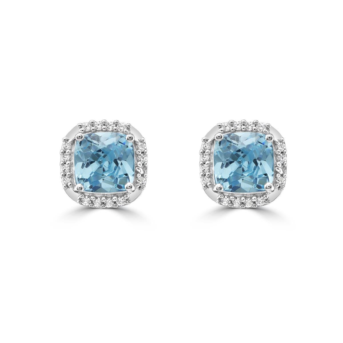Add a pop of color to your wardrobe with these stunning blue topaz studs featuring sparkling diamonds in a halo design. Set in 14K White Gold, these stud earrings feature 5x5mm cushion cut blue topazes, with diamonds totaling 0.07ct in weight. The