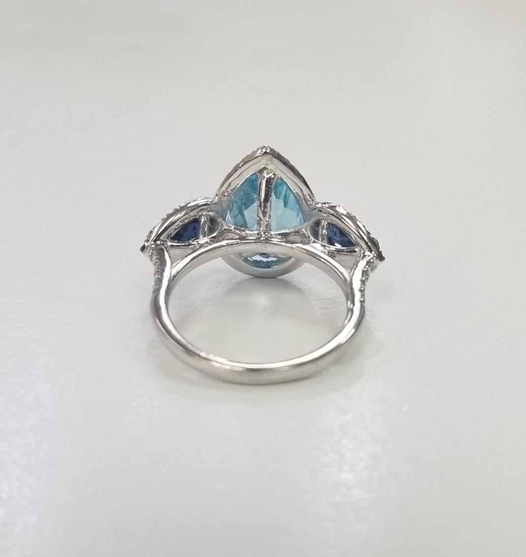 Contemporary  14k White Gold Blue Topaz, Blue Sapphire and diamond 3 stone halo ring For Sale