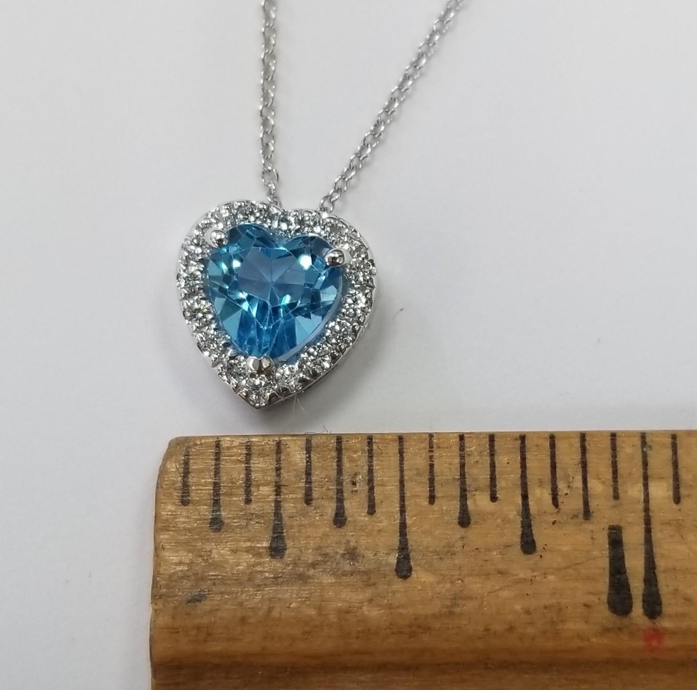 Contemporary 14k White Gold Blue Topaz Heart Shape with a Diamond Halo pendant For Sale