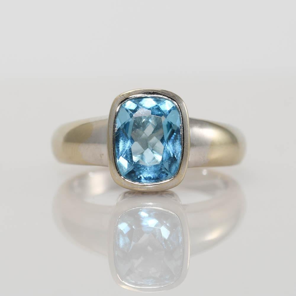 Ladies 14k white gold ring with blue topaz.
Stamped 14k and weighs 6 grams.
The topaz is rectangle antique cushion cut, approximately 2.50 carats, 10mm x 7.5mm x 4.1mm.
Very good color and cut.
Very attractive gallery works on the sides and