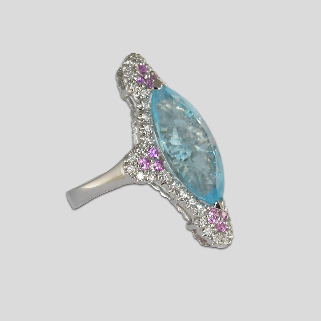 14k White gold blue topaz, diamonds and pink sapphire Ring 
Stamped 14k and weighs 6.6 grams.
The blue topaz measures 19mm by 10mm, excellent cut and faceting.
On the sides are round brilliant cut diamonds, .50 total carats, h to i color, si