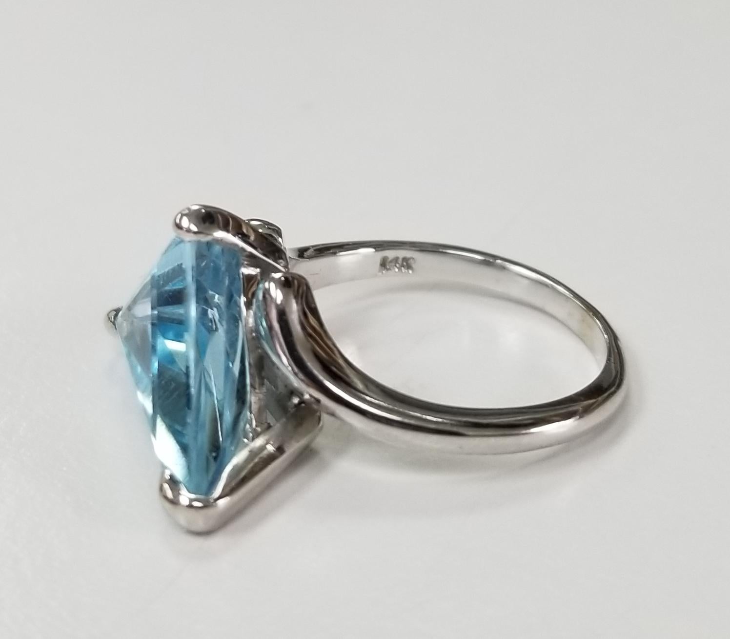 14k yellow gold Blue Topaz Triangular cut weighing 6.46cts.  This ring is a size 6.5 but we will size to fit for free.