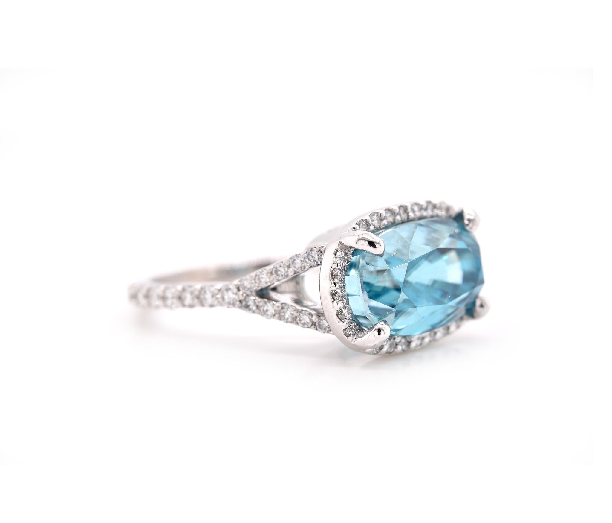 Designer: custom 
Material: 14k white gold
Zircon: 1 oval cut blue zircon = 10.09ct
Diamonds: 58 round brilliant cuts = 0.67cttw
Color: G	
Clarity: VS
Ring Size: 7 ¼ (please allow two additional shipping days for sizing requests)
Dimensions: ring