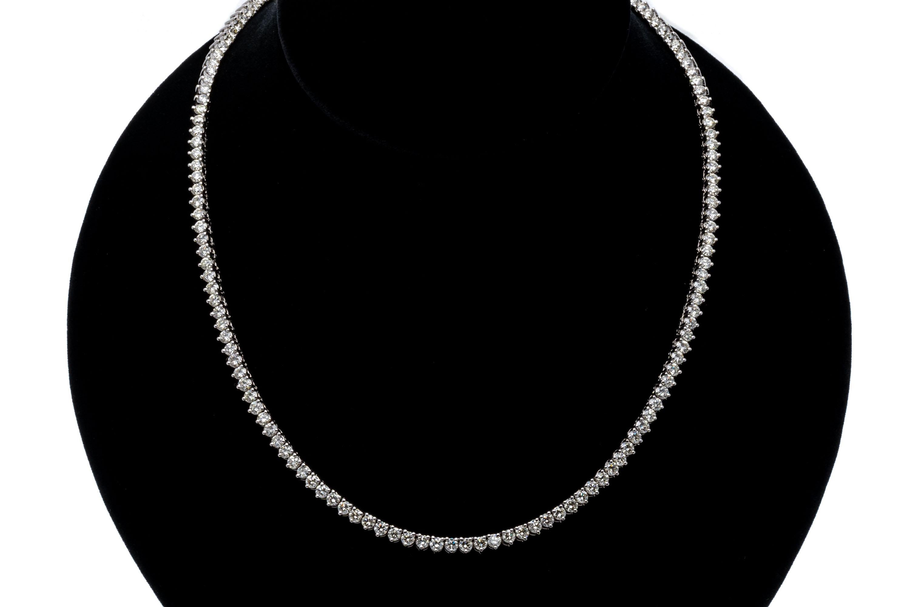14k white gold necklace. This elegant necklace is a white gold diamond line neck, with the slightest taper of round brilliant cut diamonds set into three prong mountings to show off the stones and are approximately 11.32 TCW in weight, range from