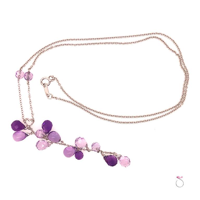 Beautiful Amethyst neckalce with varrying purple hues on 14k white gold chain. This gorgeous necklace features 12 briolette cut Amethyst Gemstones suspended from a heart shape decorative joint and attached to 14k white gold rolo link chain. The