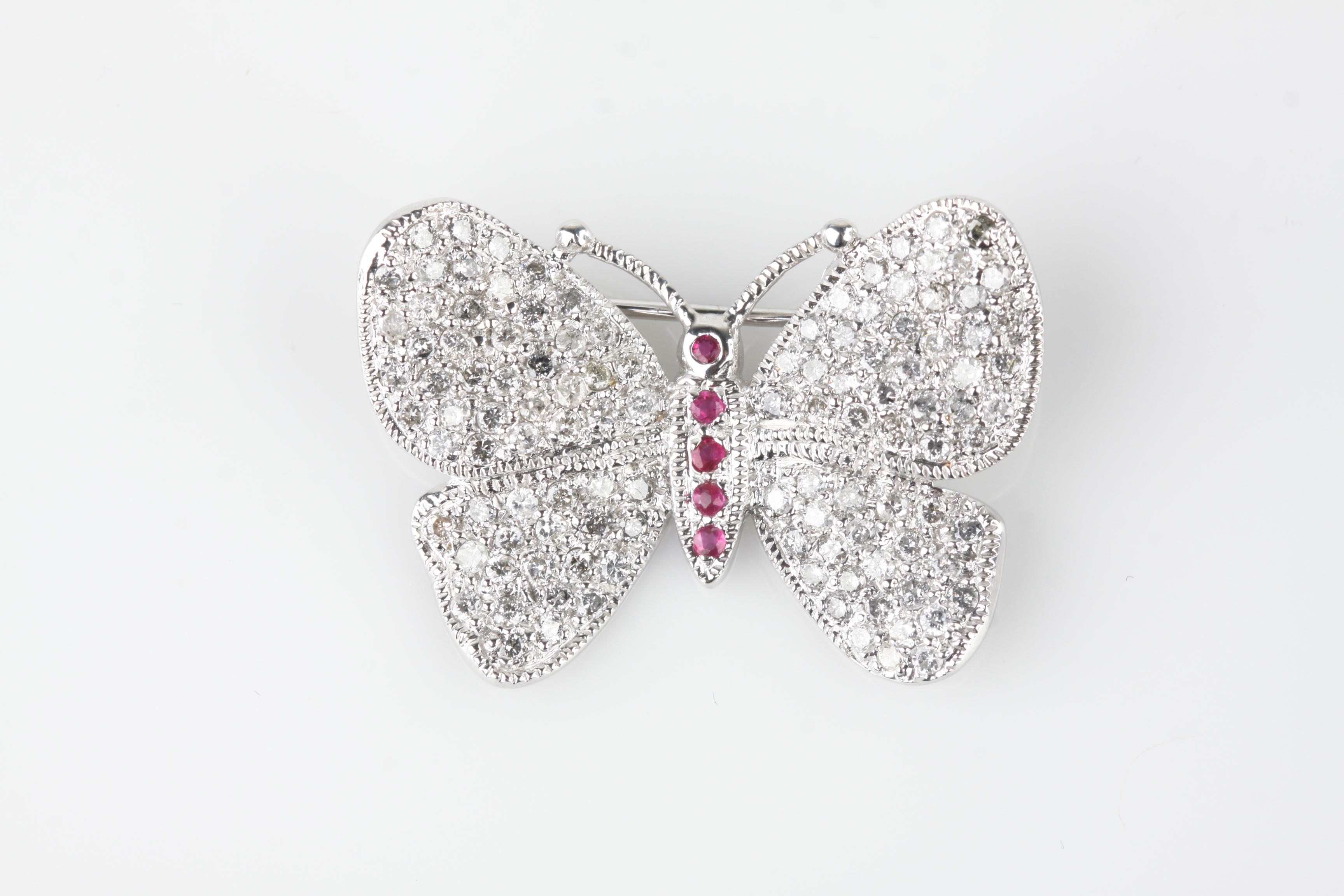 Gorgeous Unique White Gold Butterfly Brooch
Features Pave Set Diamonds in Wing and Ruby Accents on Body
Total Diamond Weight = 1.87 ct
Average Color = G - I
Length of Brooch = 34 mm
Length of Body = 13 mm
Total Mass = 6.92 grams