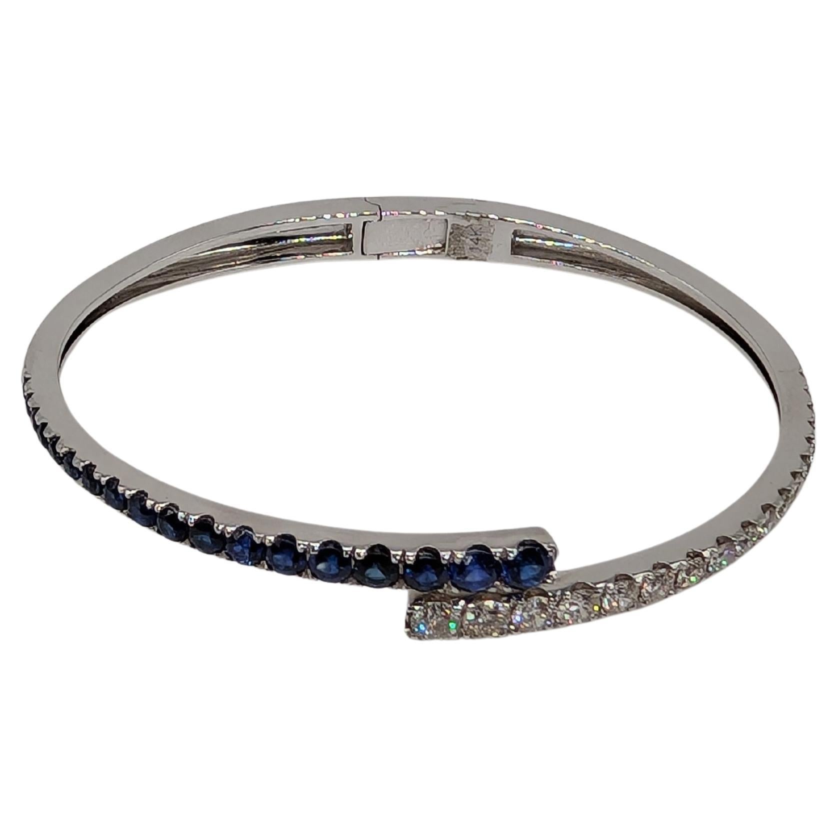 14k White Gold Bypass bangle with round cut graduated sapphires and diamonds