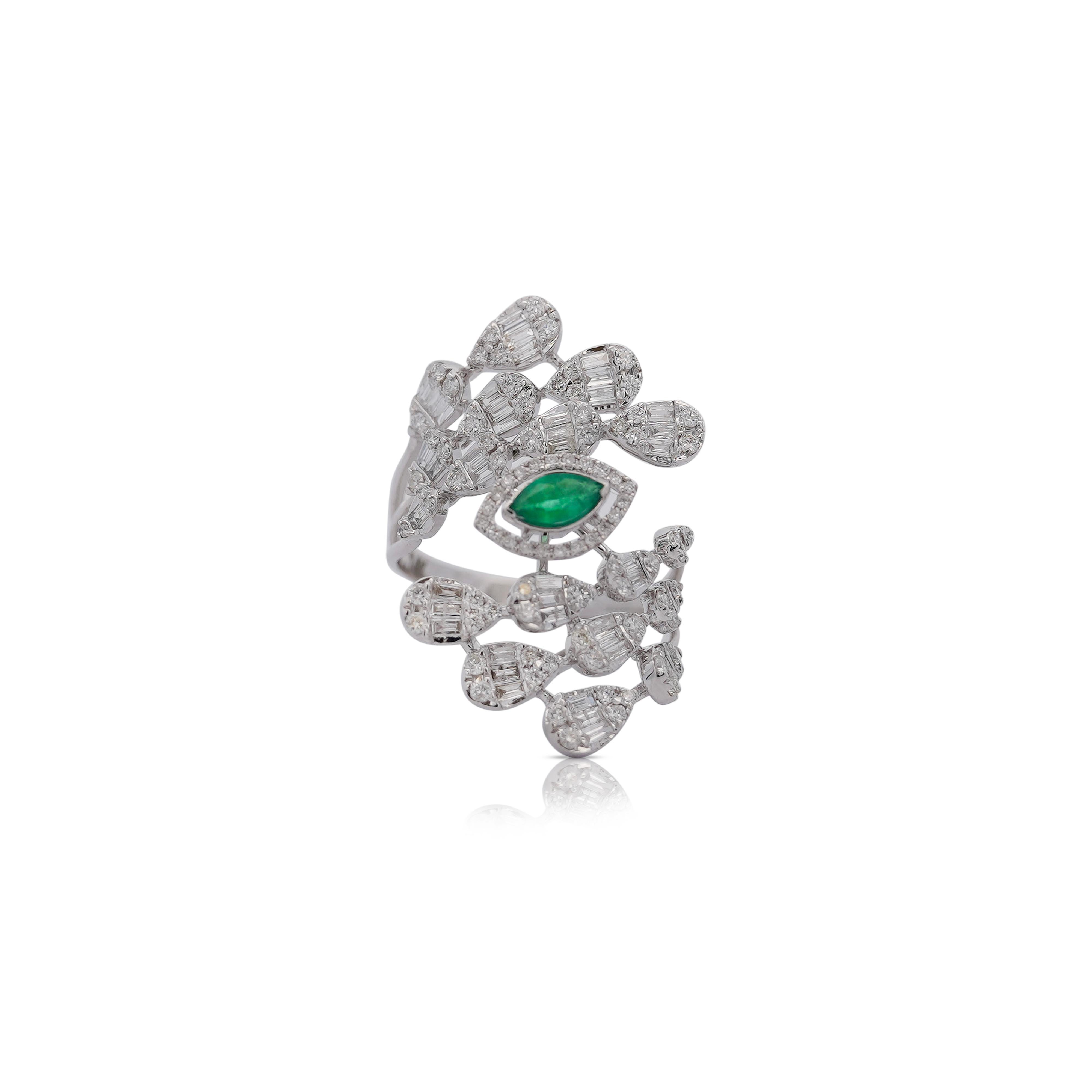 This 14K White Gold Emerald and Diamond Ring featuring a vibrant 0.11 carat Marquise cut Emerald, complemented by 1.24 carats of Round and Baguette cut Diamonds. The gemstones are set in 14 Karat white gold. The ring weighs 5 grams and is sized at