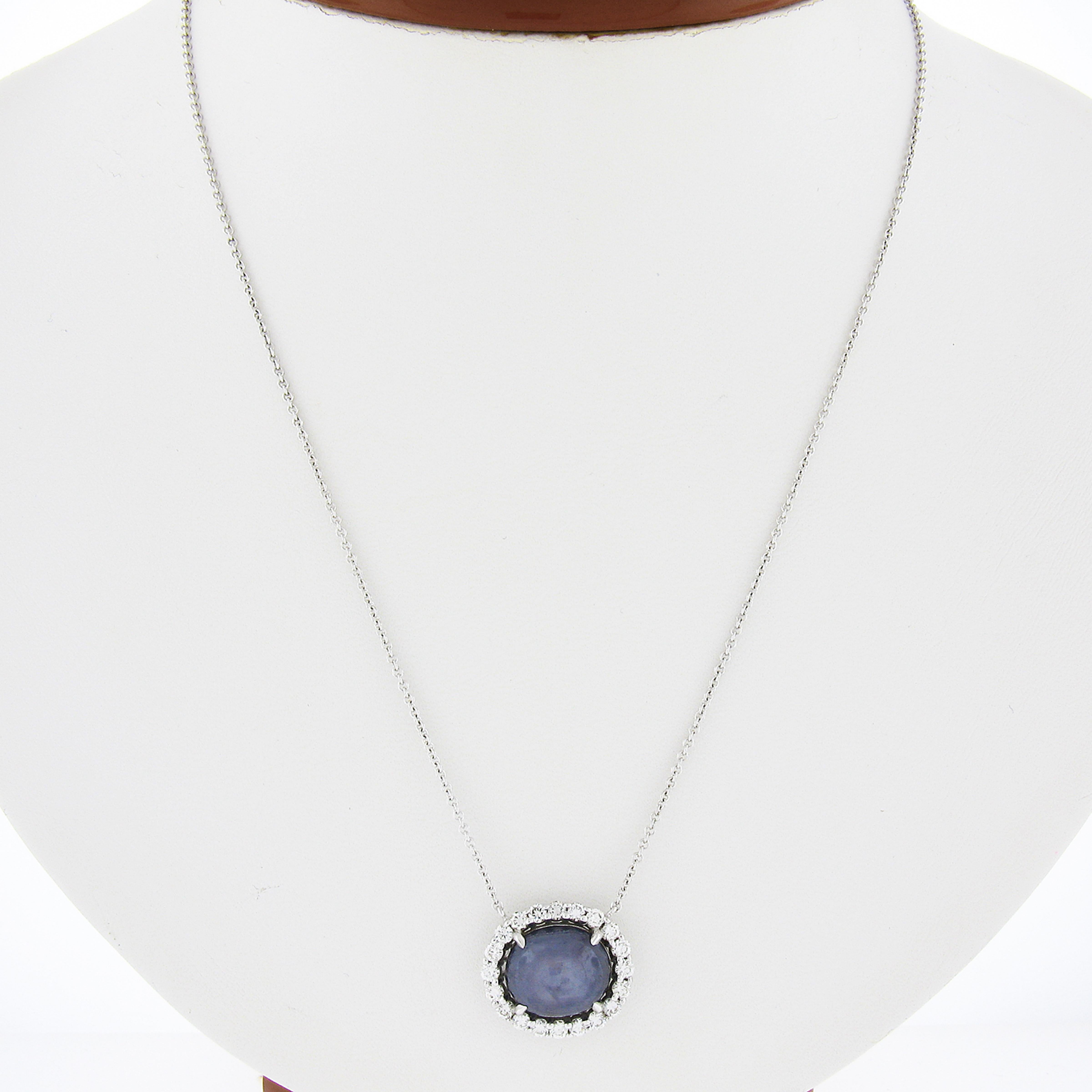 Here we have a truly breathtaking pendant necklace that is crafted in solid 14k white gold featuring a very fine, 100% natural, star sapphire neatly set at the center of a brilliant diamond halo. The oval cabochon cut solitaire is GIA certified and
