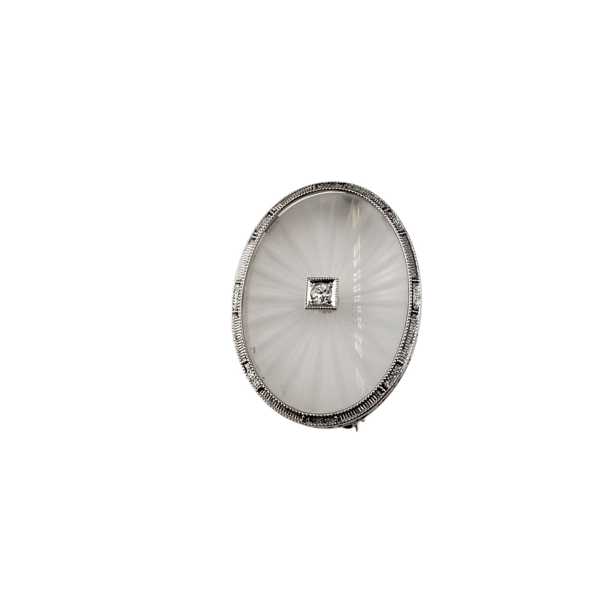 14K White Gold Camphor Glass and Diamond Brooch/Pin-

This lovely 14K white gold brooch features a delicate camphor glass centerpiece, giving it a radiant, almost icy appearance. At its center sits one round brilliant cut diamond, adding a touch of