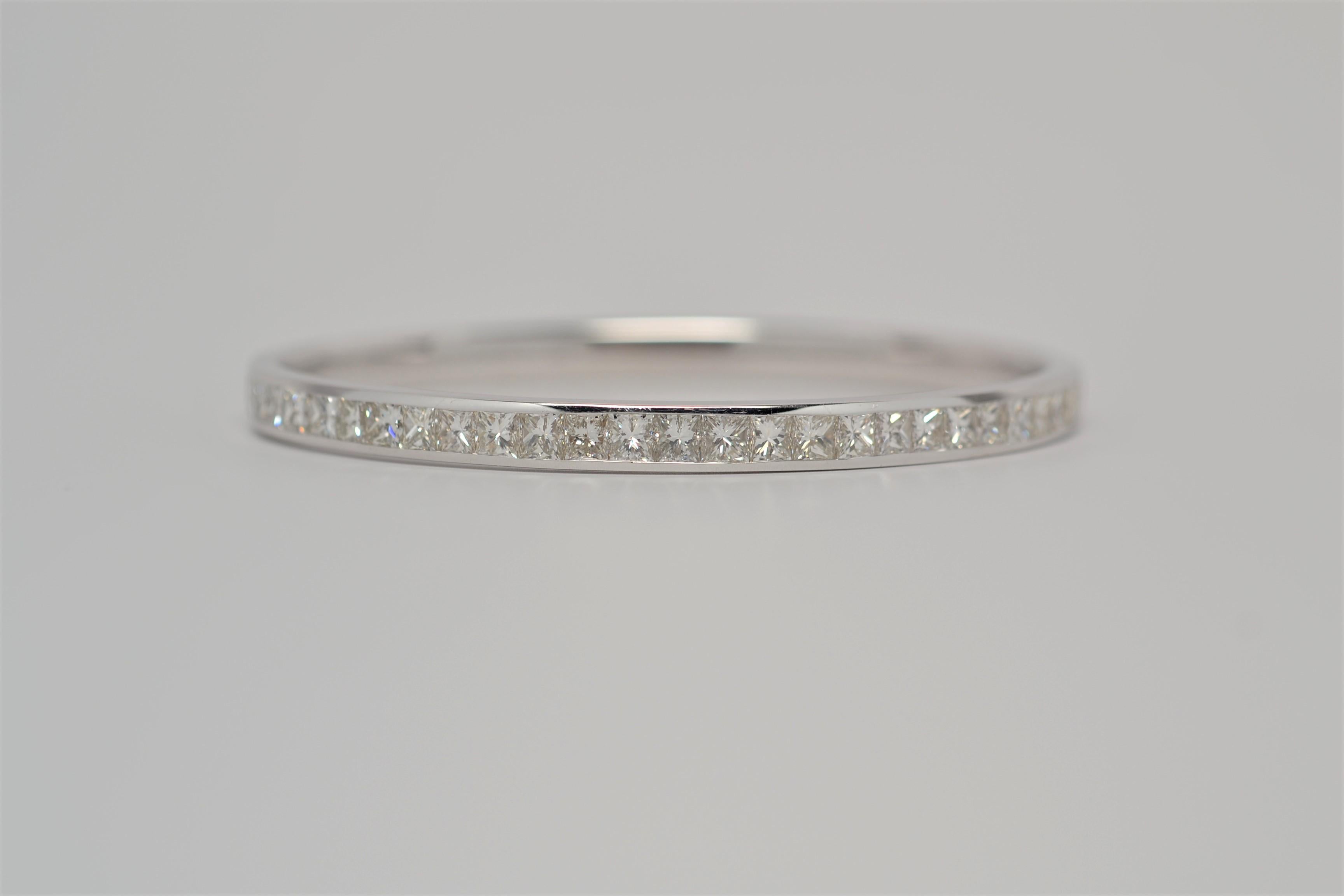 Ladies' 14K White Gold Bangle Bracelet with Princess Cut Diamonds. This finely made bracelet is channel set with twenty-eight (28) Princess Cut Diamonds going half way around for a total weight of 6.25ct. The diamonds are in the color grade range (I