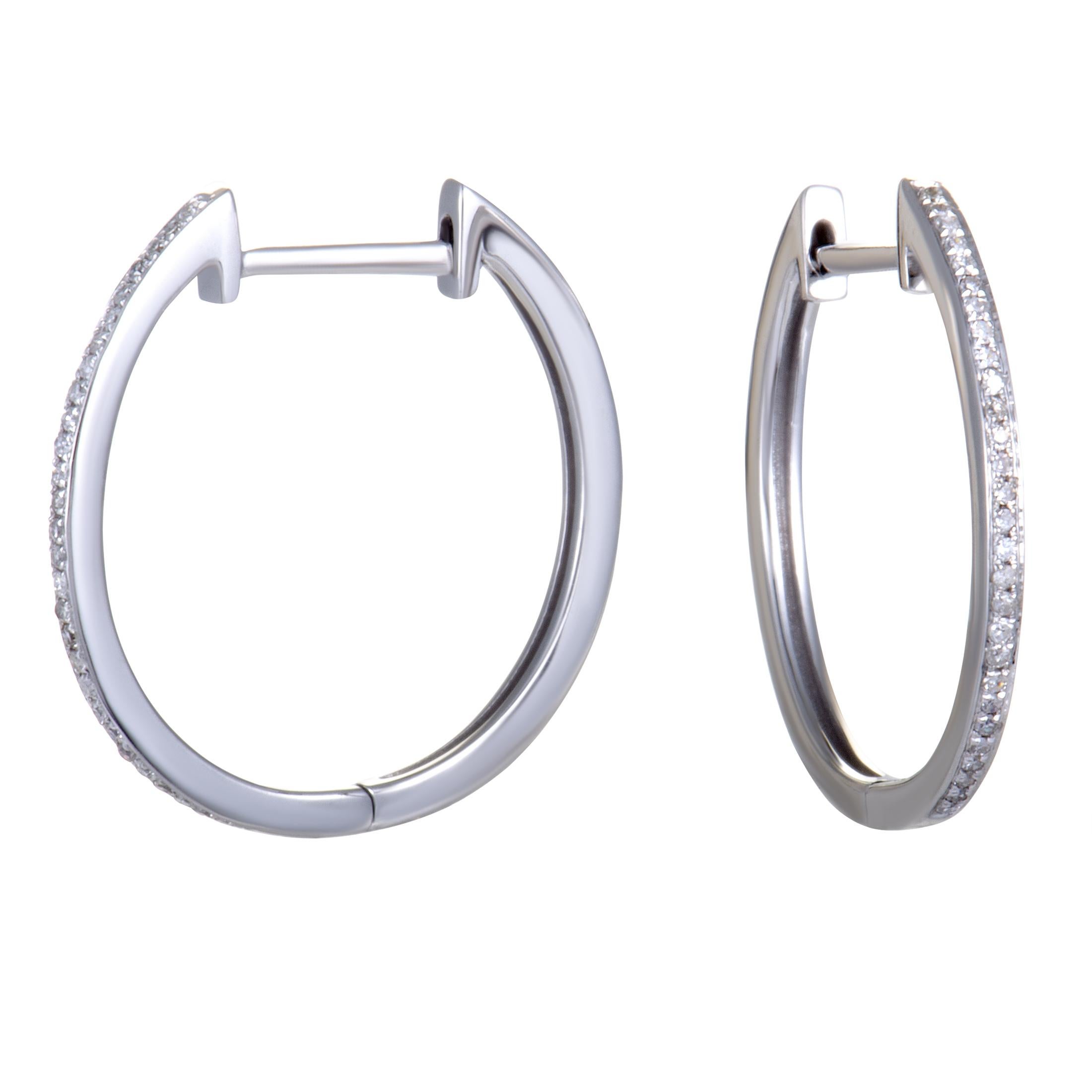 Exquisitely tasteful and elegant, these sublime hoop earrings will add a classy touch to any outfit. Made of gleaming 14K white gold, the earrings are set with scintillating diamonds that weigh in total 0.10 carats.

