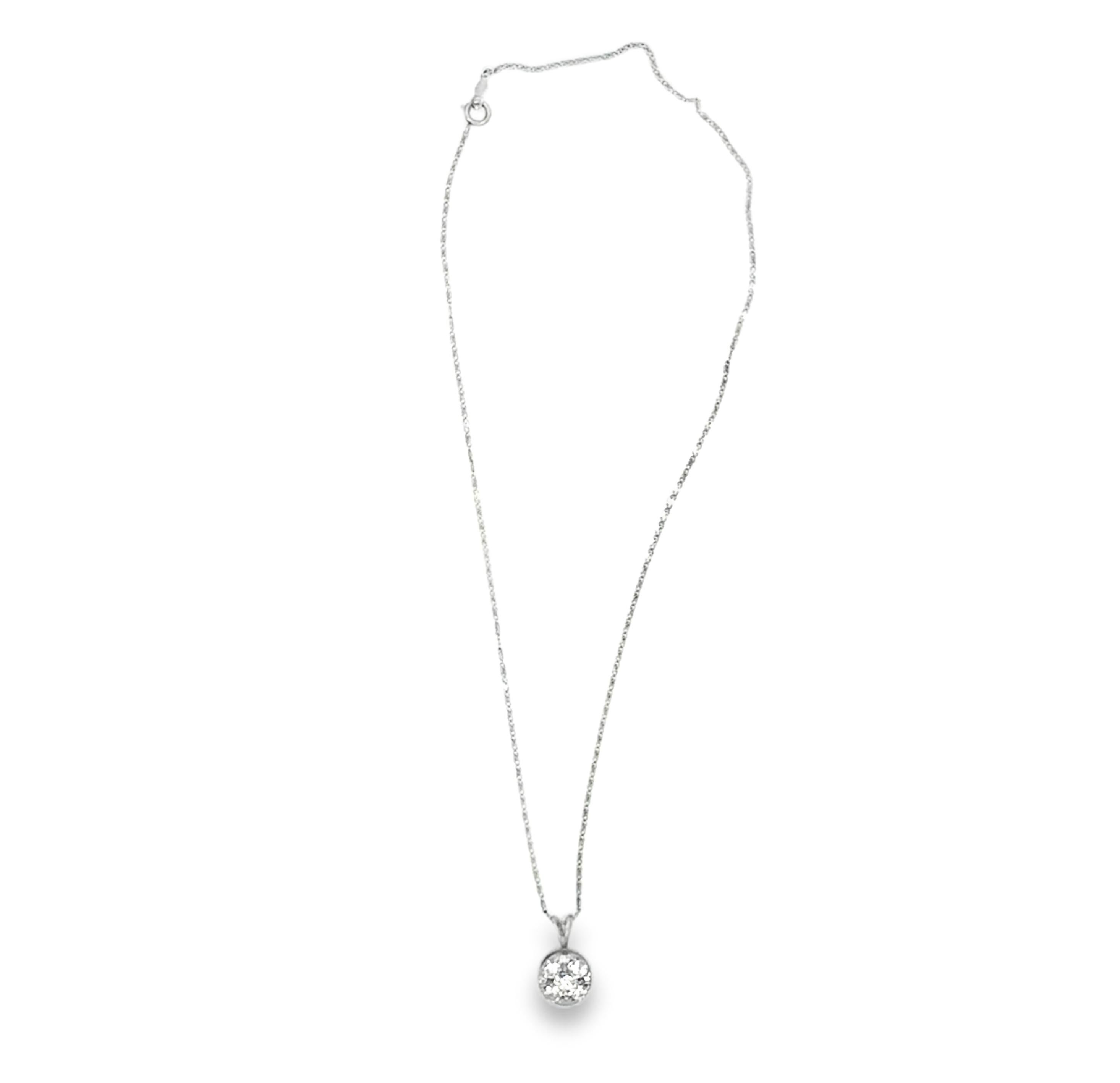 This classic and pretty circular diamond pendant necklace is a timeless piece that exudes understated elegance. Crafted in 14K white gold, the pendant measures 10 millimeters in diameter and features 5 round brilliant-cut diamonds, totaling 1 carat