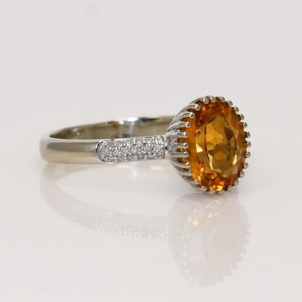 Ladies citrine quartz and diamond ring in 14k white gold setting.
Stamped 14k and weighs 4 grams gross weight.
The oval-shaped citrine has fancy faceting on the bottom, a nice yellowish-orange color, and 2.25 carats.
The diamonds are single cuts,