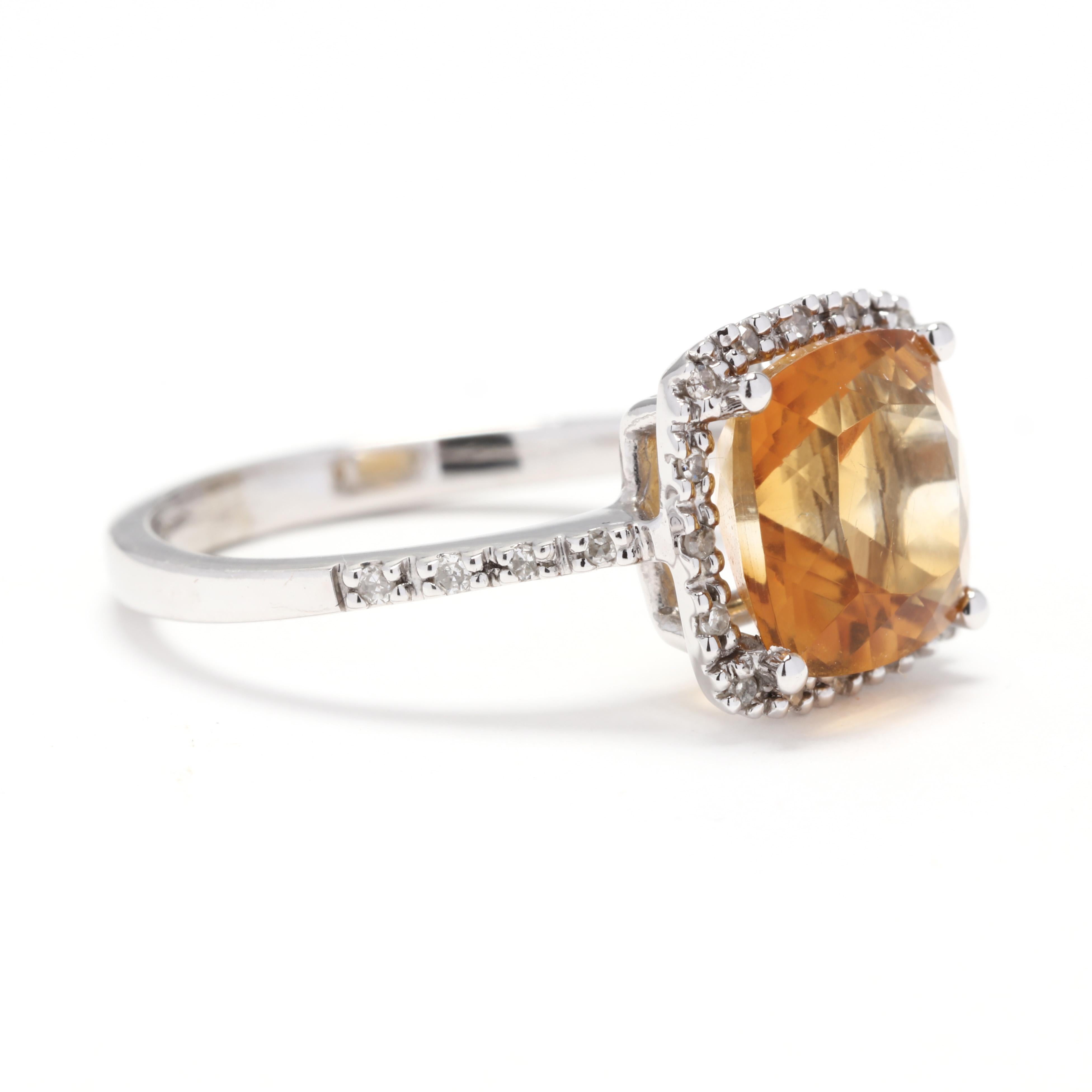 A 14 karat white gold, citrine and diamond halo ring. This ring is centered on a cushion cut citrine weighing approximately 1.95 carats, surrounded by a halo of diamonds and with diamonds down a thin band weighing approximately .10 total