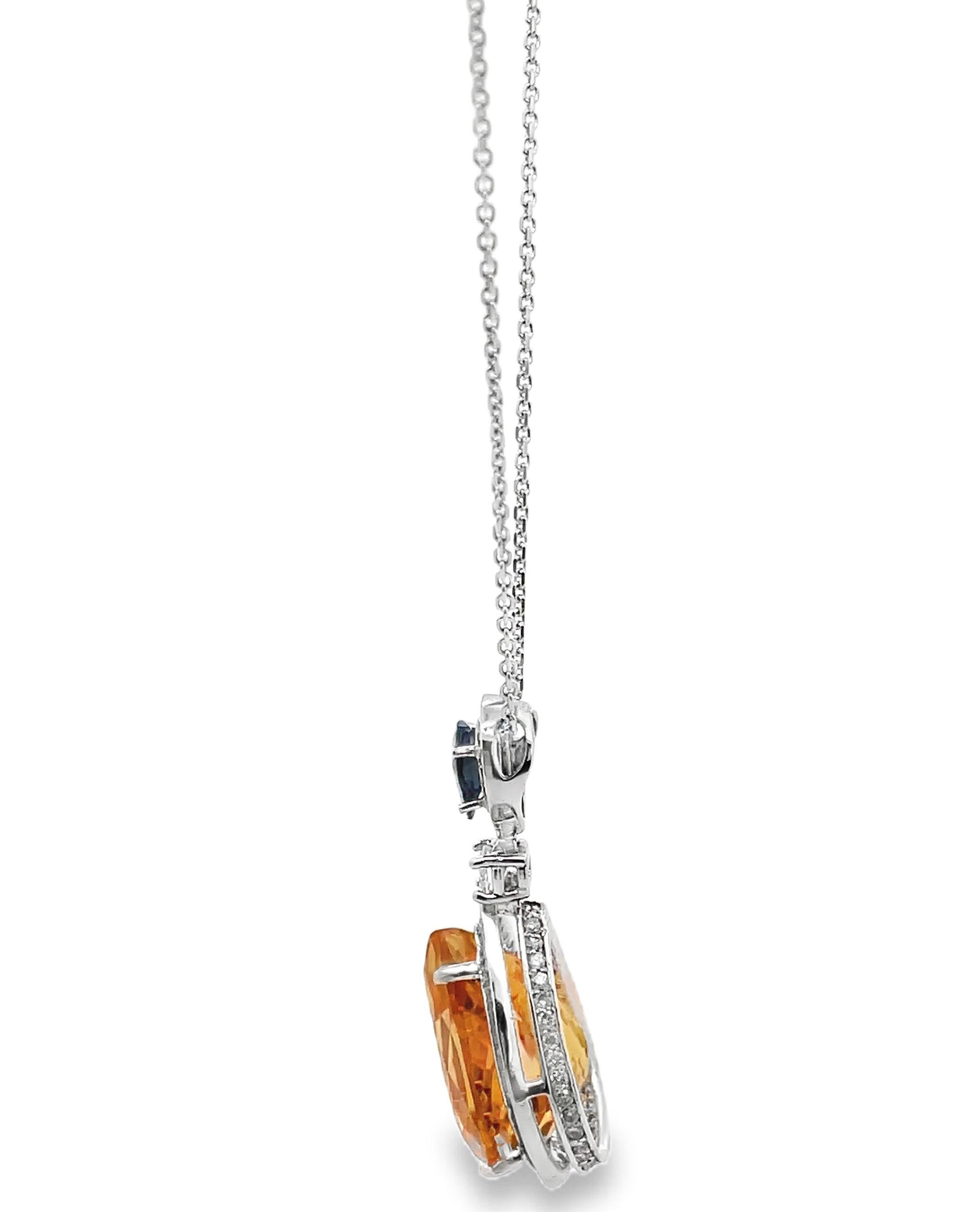 14K white gold pendant necklace with 90 diamonds weighing 0.91 carat total.  On the top there is one pear shaped blue sapphire weighing 0.54 carat.  In the center there is one citrine weighing 12.28 carats.

- Necklace is 18 inches long.