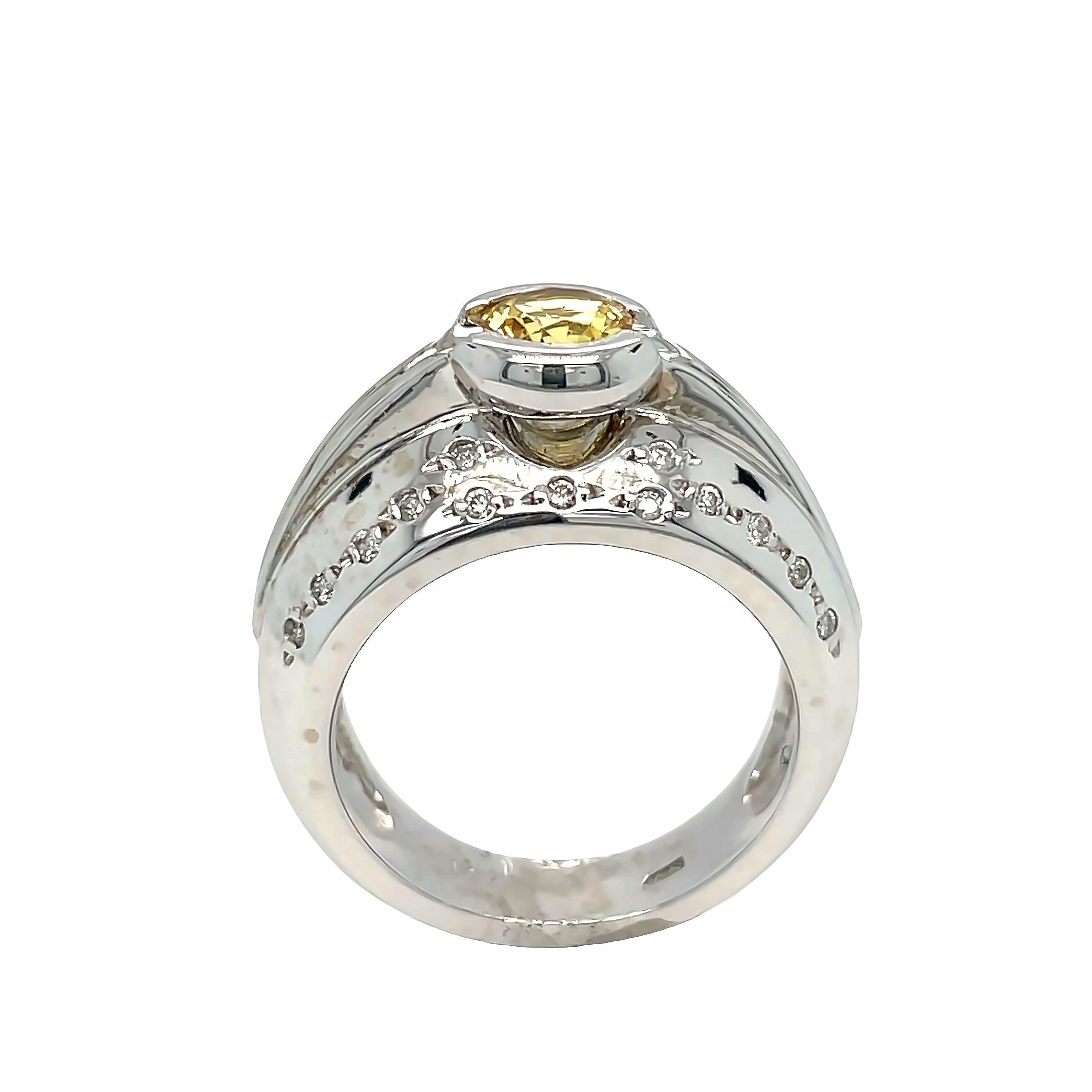 Elegant and contemporary, this 14K White Gold Citrine Diamond Ring features a stunning round Citrine weighing approximately 0.80 carat. Citrine is beautifully showcased in a raised semi-bezel setting, complemented by a dome setting adorned with