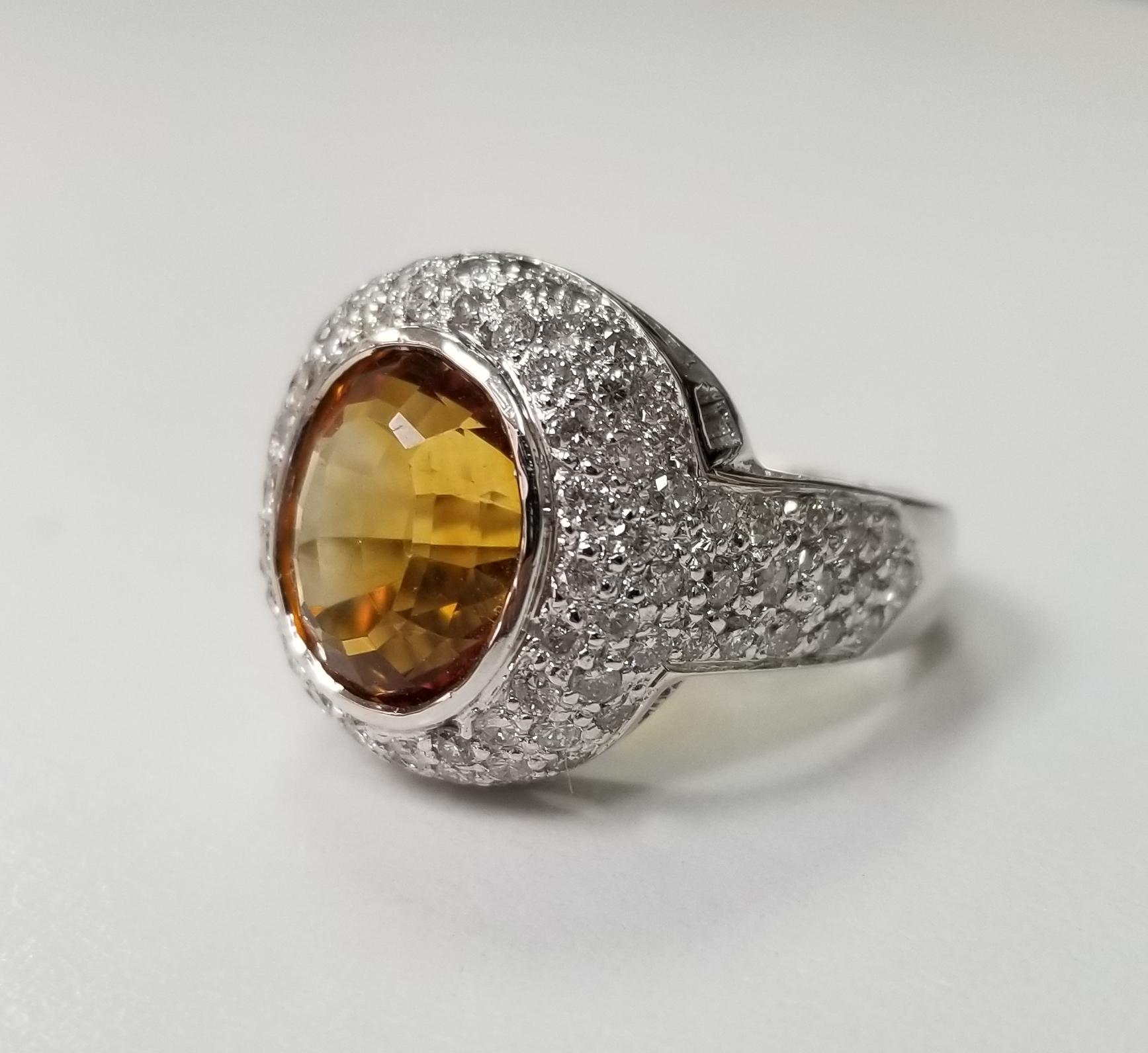 14k white gold Citrine topaz and diamond pave' ring, containing 1 oval Citrine topaz weighing 2.5cts. and 94 round full cut diamonds of very fine quality weighing 1.35ts.  This ring is a size 6 but we will size to fit for free.