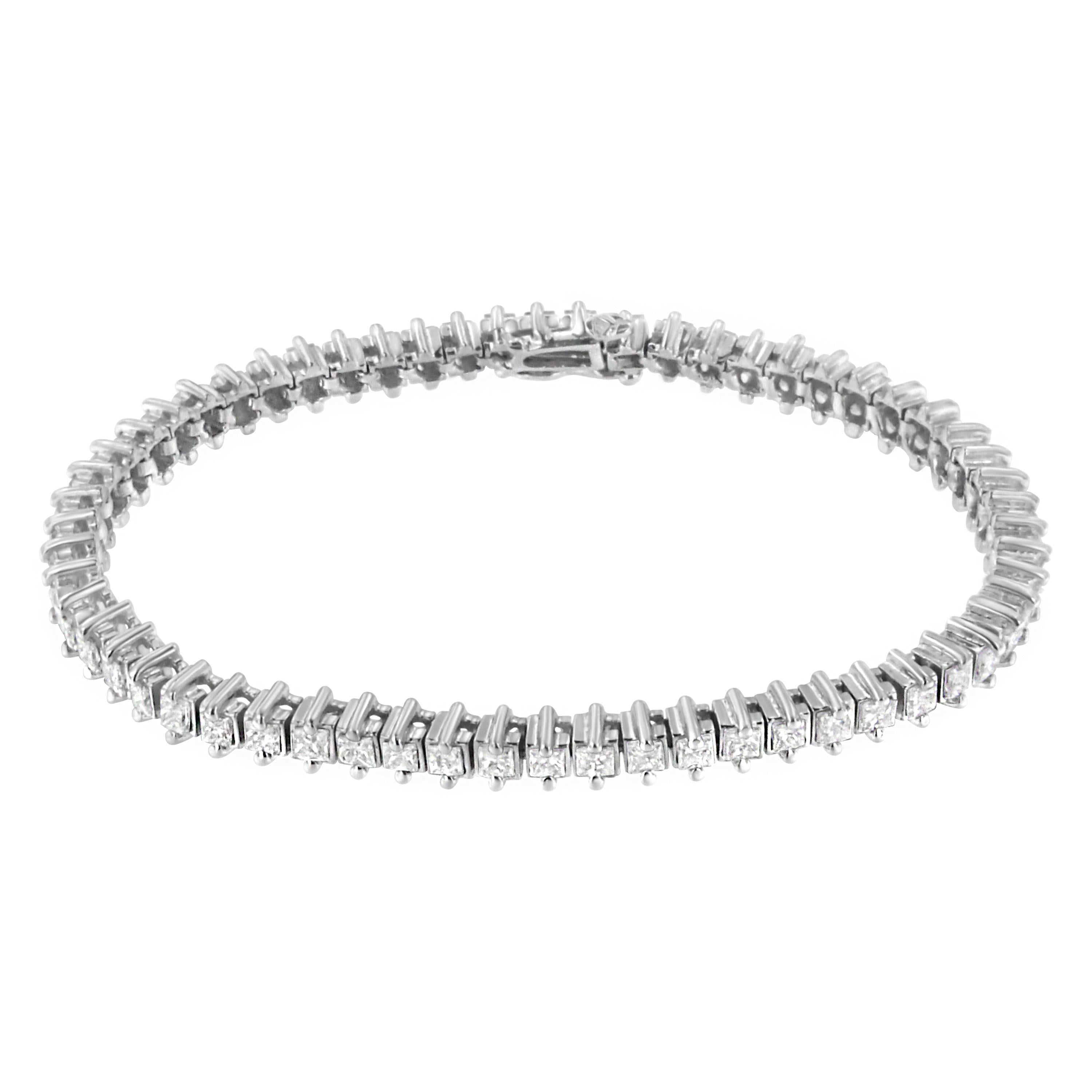 Lassen Sie sich von diesem zarten Tennisarmband mit 60 Diamanten im Princess-Schliff verzaubern, die einzeln in glänzende Glieder aus 14 Karat Weißgold gefasst sind. Jeder Stein wiegt ca. 0,08 Karat, so dass das Gesamtgewicht der Diamanten 5 Karat