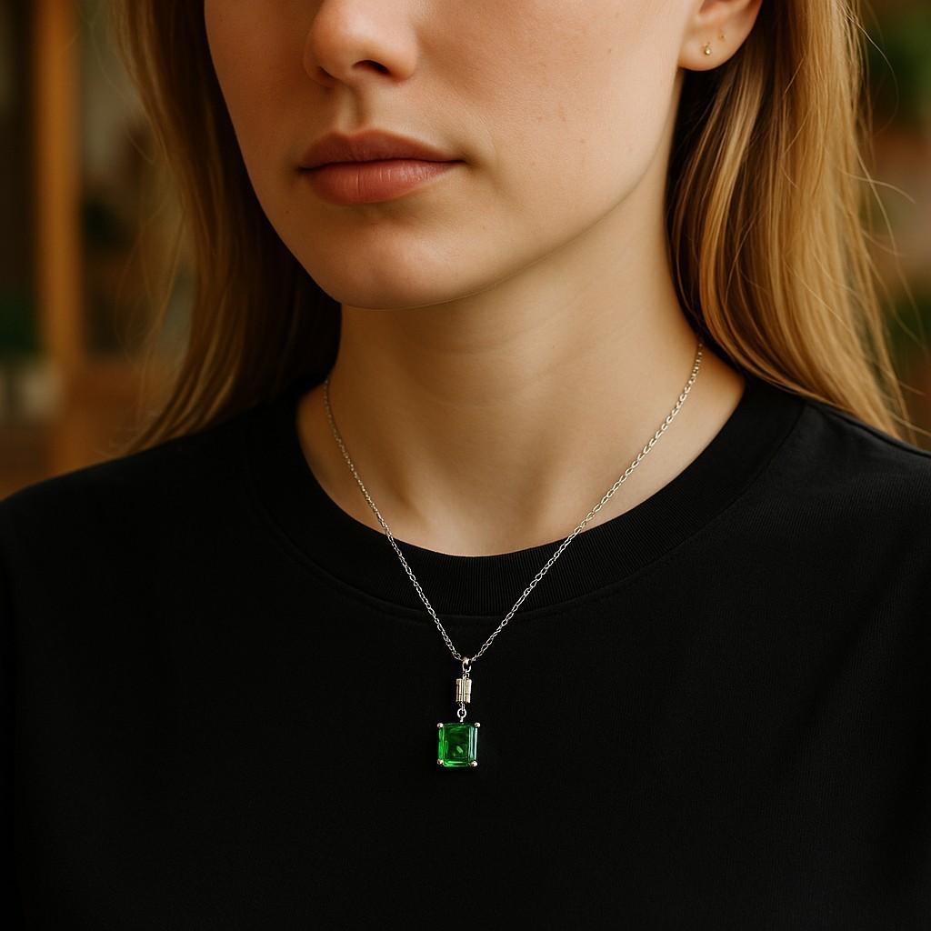 A Refined Expression of Classic Elegance
Indulge in the timeless allure of this 14K White Gold Pendant Necklace, featuring a captivating 0.70-carat Colombian emerald and a dazzling 0.20-carat emerald-cut diamond. Perfectly balanced in both